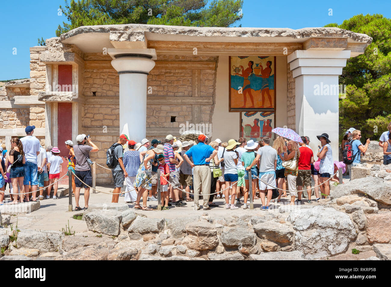 Tourist group on a guided tour in Knossos palace near south Propylaeum with procession fresco. Heraklion. Crete, Greece Stock Photo