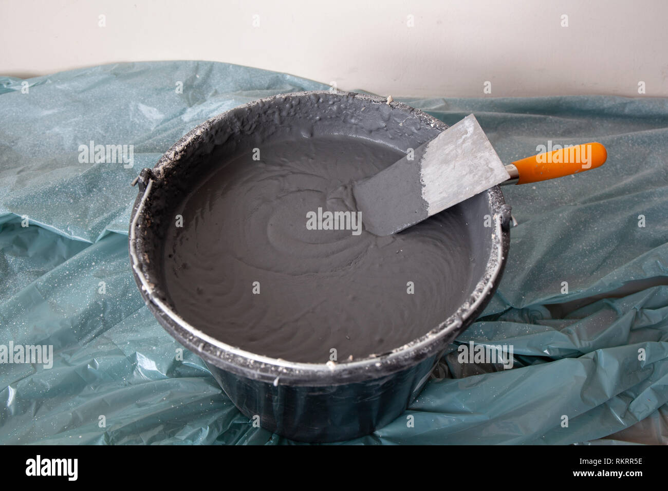 Decorative cement plaster and a trowel in a construction bucket ready for plastering Stock Photo