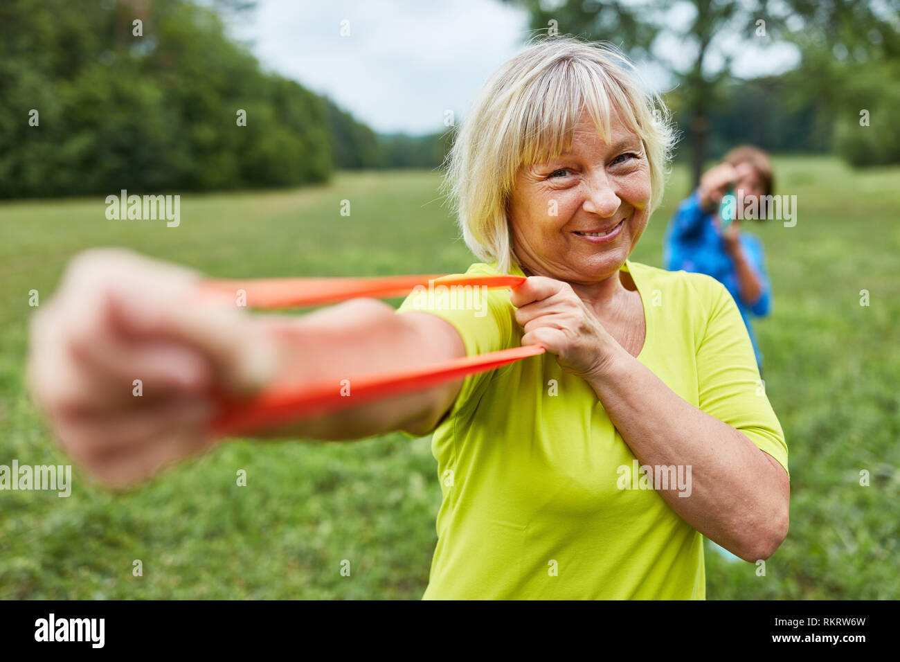Senior woman doing a rehab exercise with the exercise band or stretch band Stock Photo