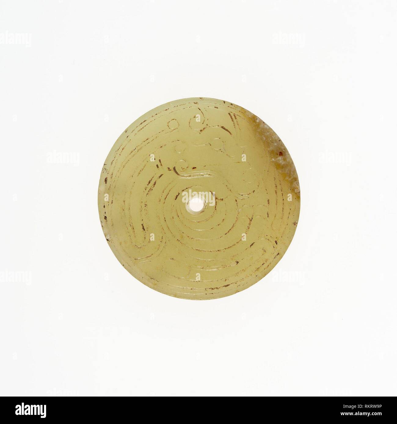 Disc with Coiled Dragon - Western Zhou period, 10th/9th century B.C. - China - Origin: China, Date: 1000 BC–800 BC, Medium: Jade, Dimensions: Diam. 1 Stock Photo