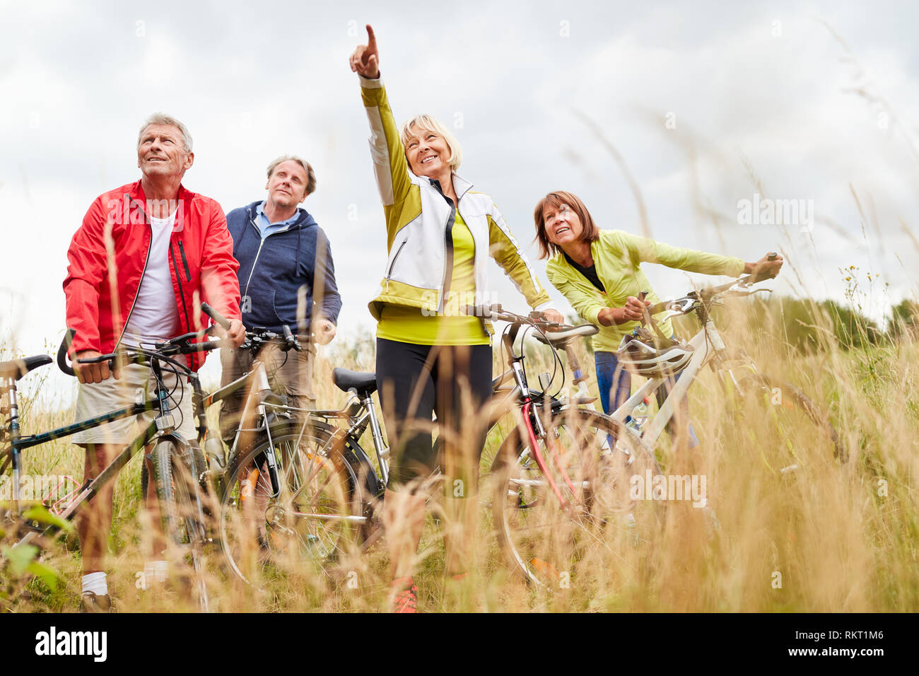 Group of active seniors together makes a bike ride in summer vacation Stock Photo