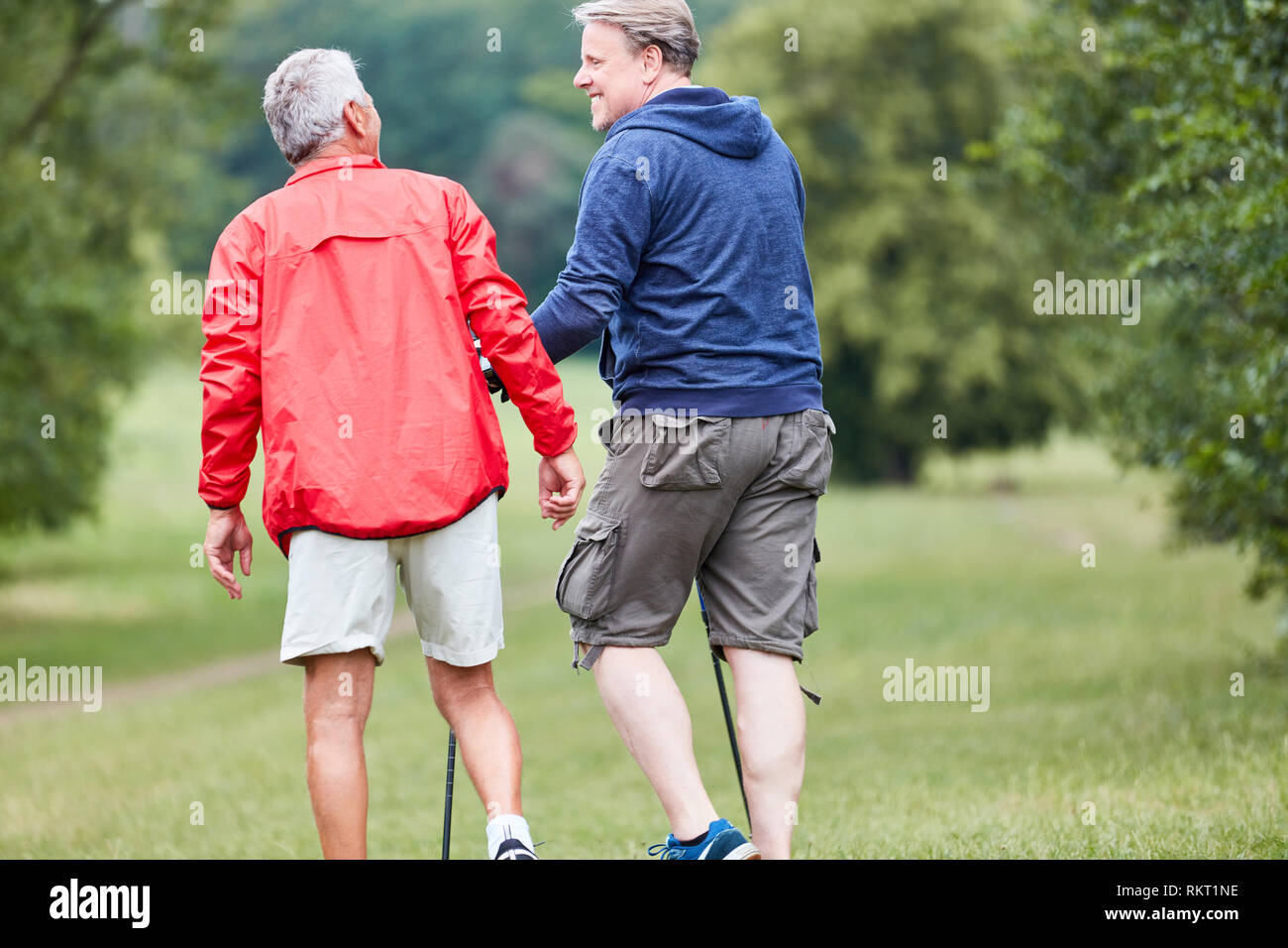 Two seniors together while hiking in nature on active vacation Stock Photo