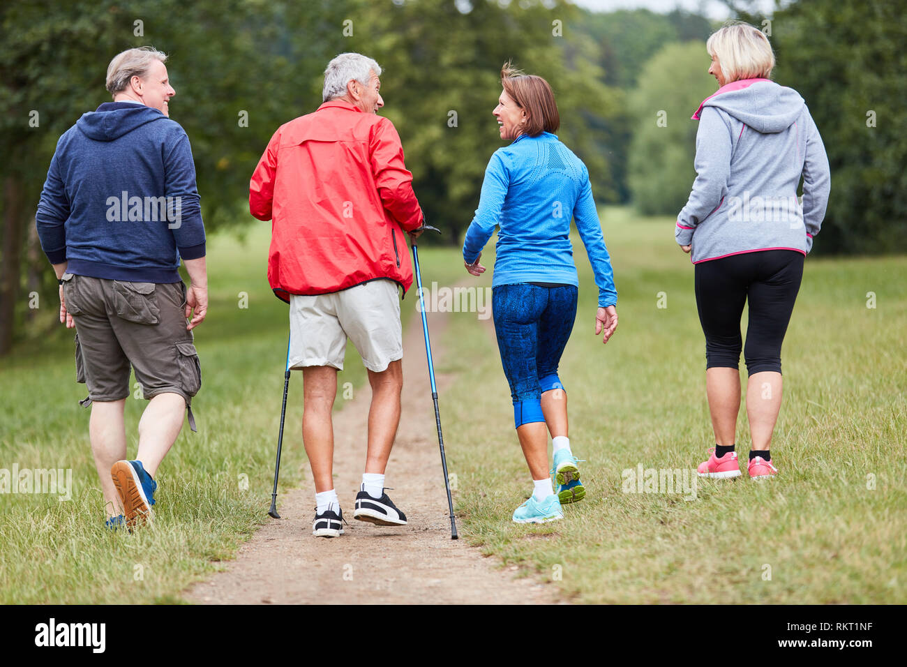 Group of active seniors as friends do nordic walking in nature Stock Photo