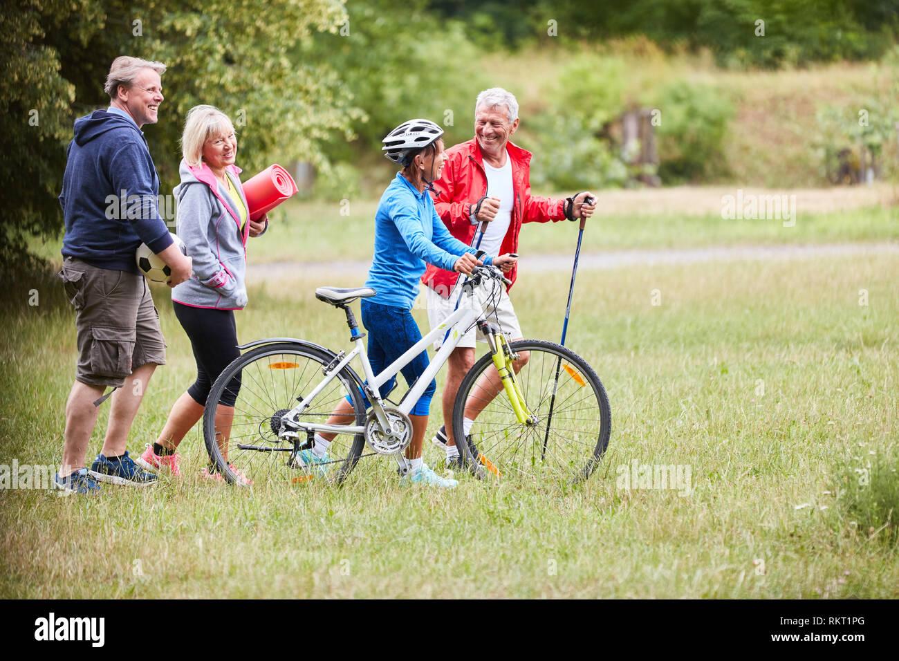 Vital group seniors doing sports together in summer in nature Stock Photo