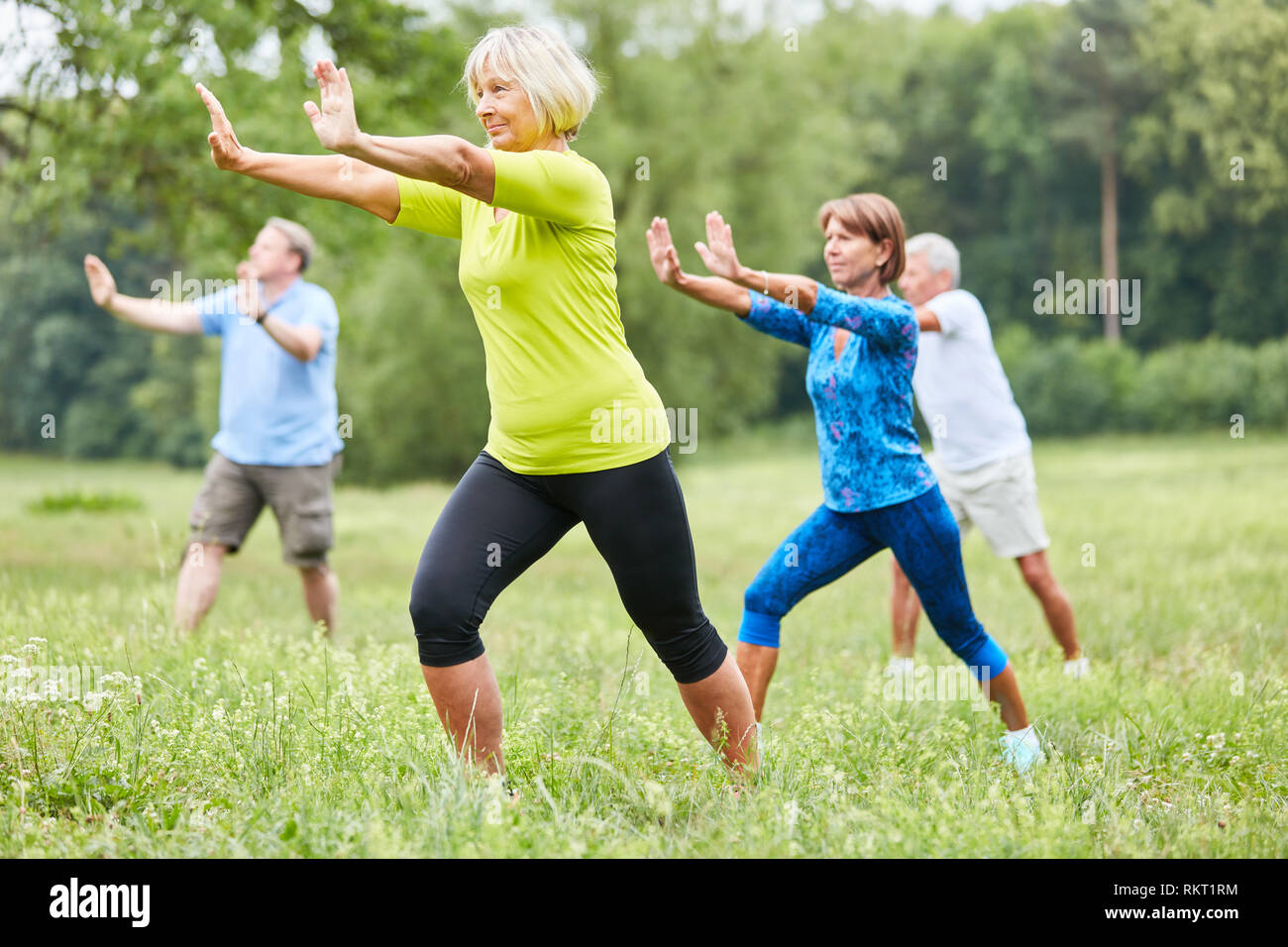 Seniors in the wellness class do Qi Gong or Tai Chi exercise for relaxation Stock Photo