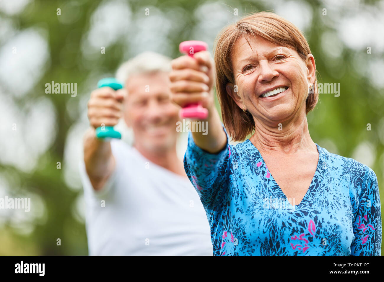 Active senior woman and partner in weight training for strength and muscle building Stock Photo