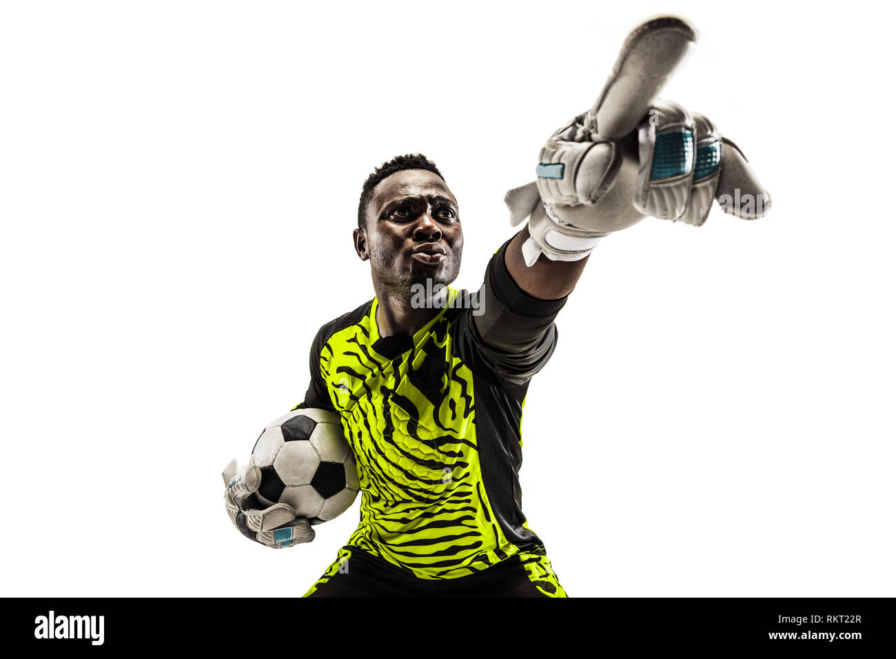 One african male soccer player goalkeeper pointing away and screaming isolated on white background. Appeal to the referee, order to defenders and human emotions concept Stock Photo