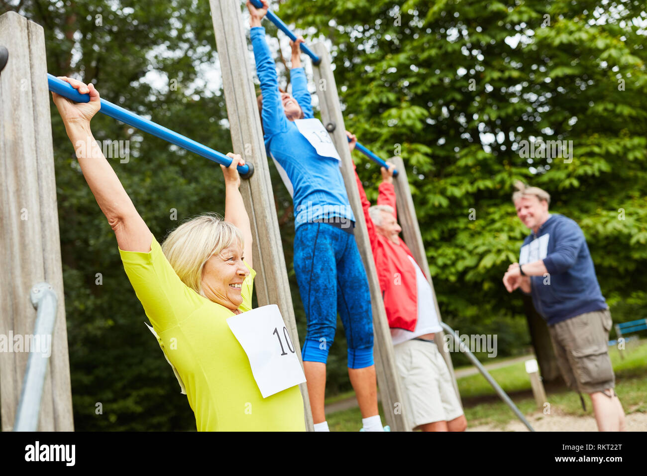 Vital seniors group on the trim you parcours during the pull-up competition Stock Photo