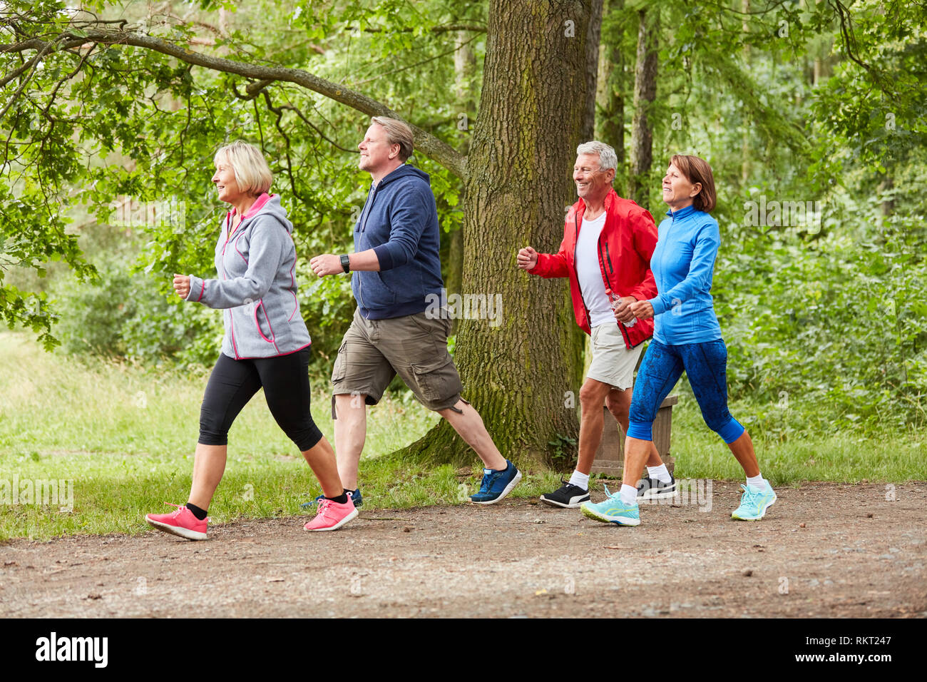 Group of seniors walking or walking as a fitness training in nature Stock Photo