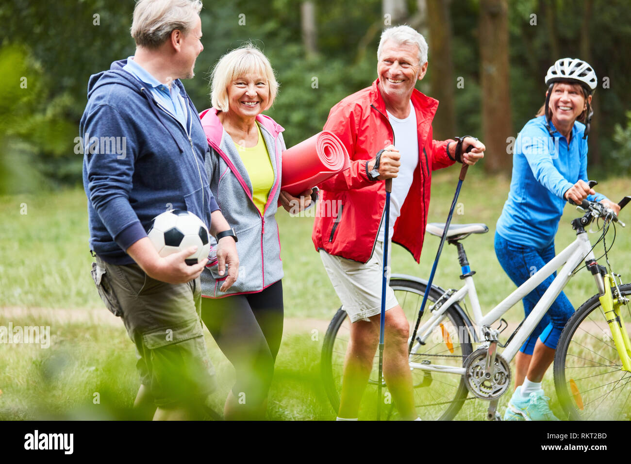 Four active seniors are looking forward to leisure sports together in summer Stock Photo