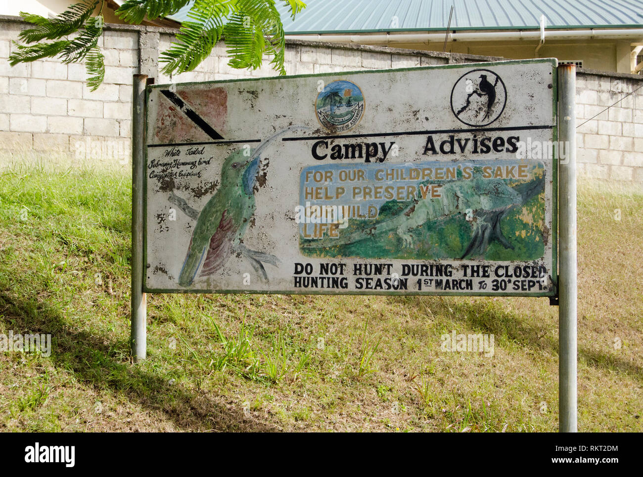 SCARBOROUGH, TRINIDAD AND TOBAGO - JANUARY 7, 2019:  A handpainted sign promoting anti-hunting law on the island of Tobago.  Featuring 'Campy' the whi Stock Photo