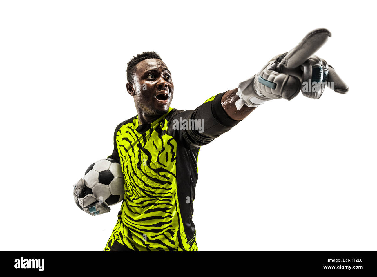 One african male soccer player goalkeeper pointing away and screaming isolated on white background. Appeal to the referee, order to defenders and human emotions concept Stock Photo