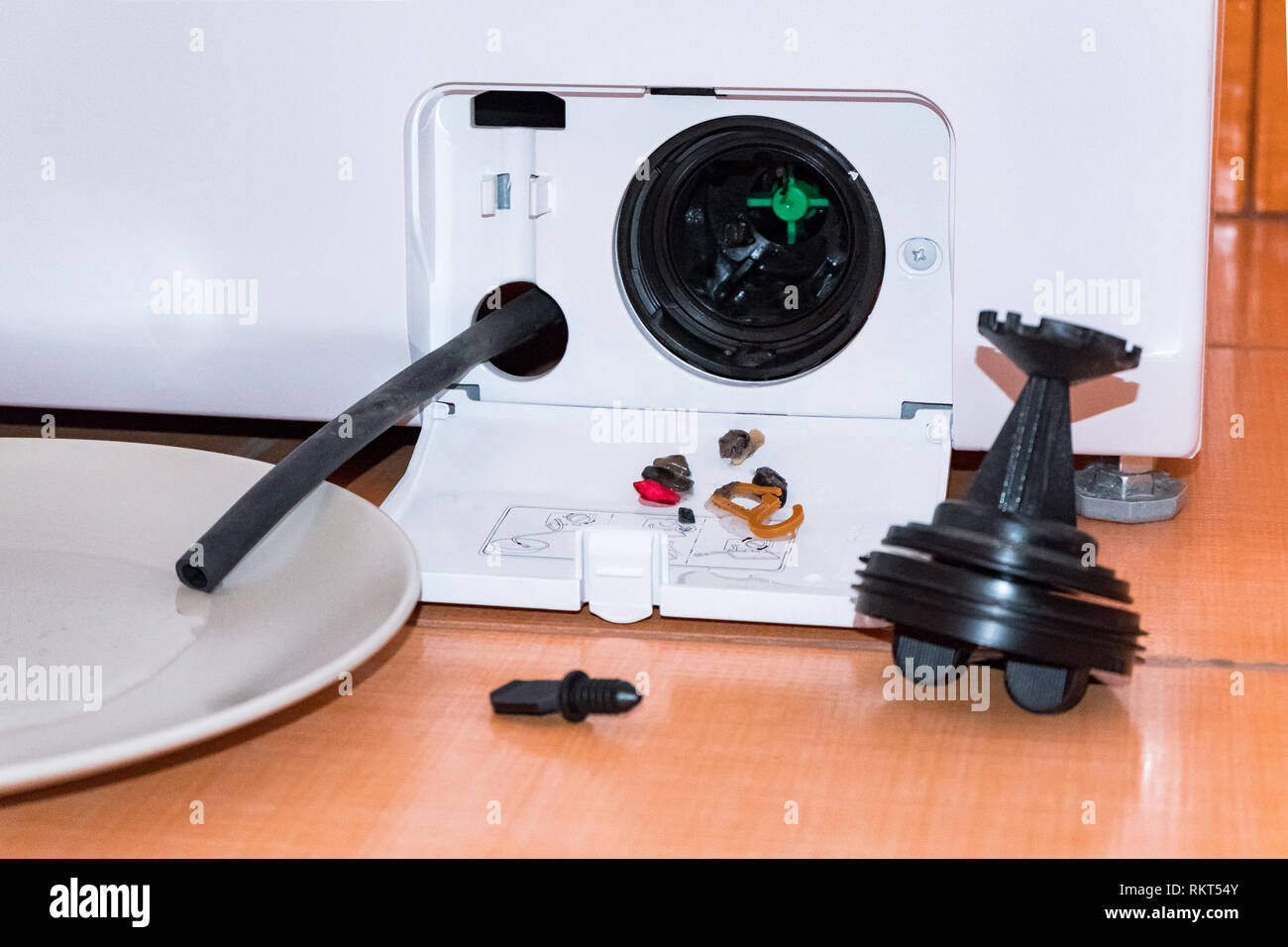 Cleaning the washing machine. How to clean the filter from small parts, debris. Stock Photo