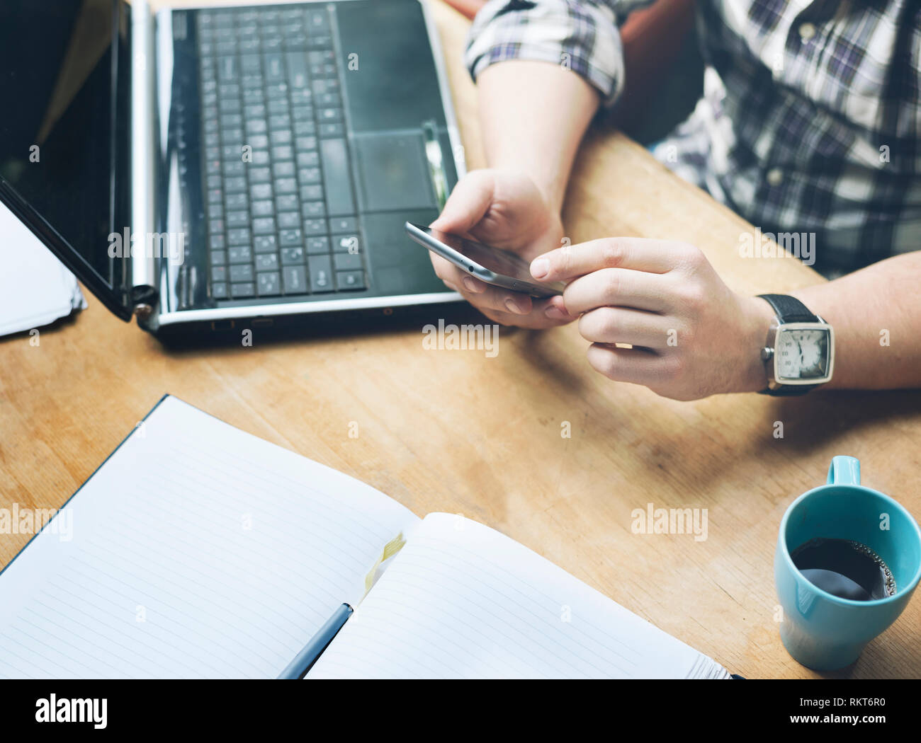 Workspace design studio office. Top view of working desk with laptop, notebook and coffee cup. Closeup of business man working on his project using mo Stock Photo