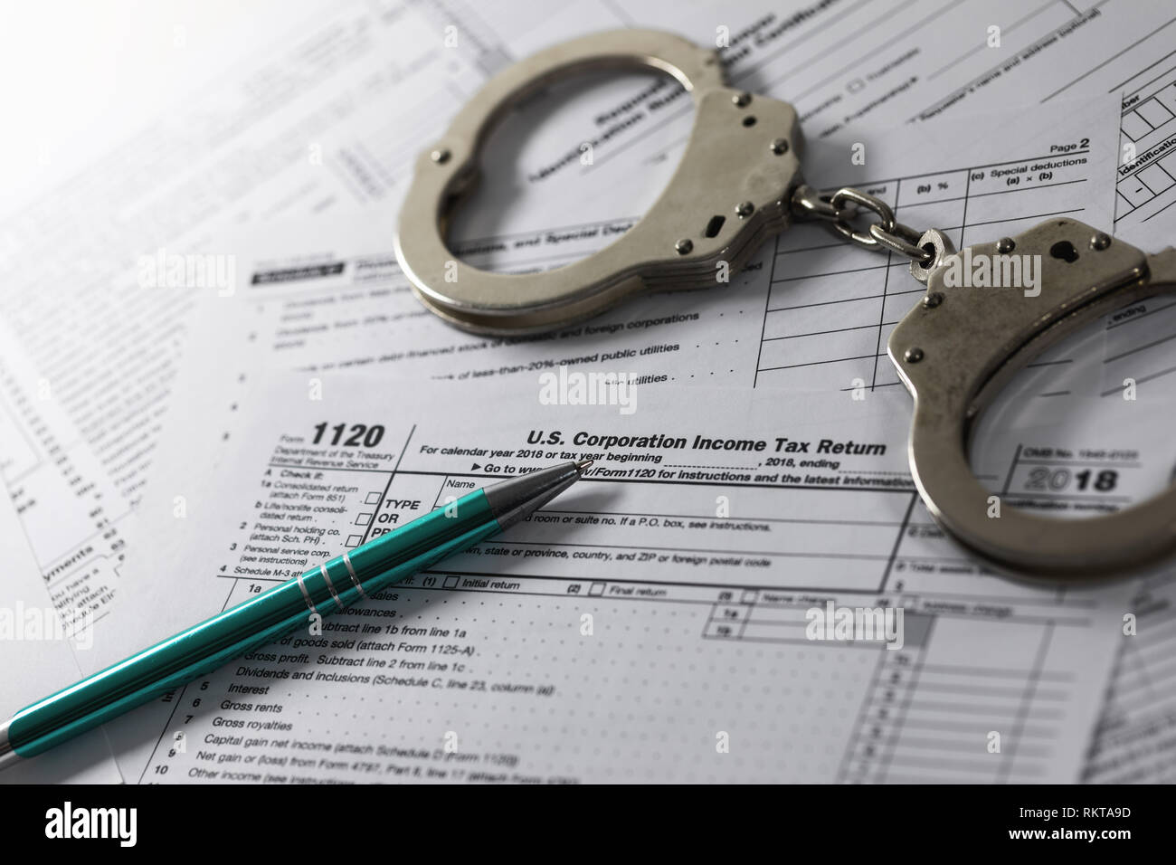 tax evasion and avoidance concept. annual income declaration form and handcuffs Stock Photo