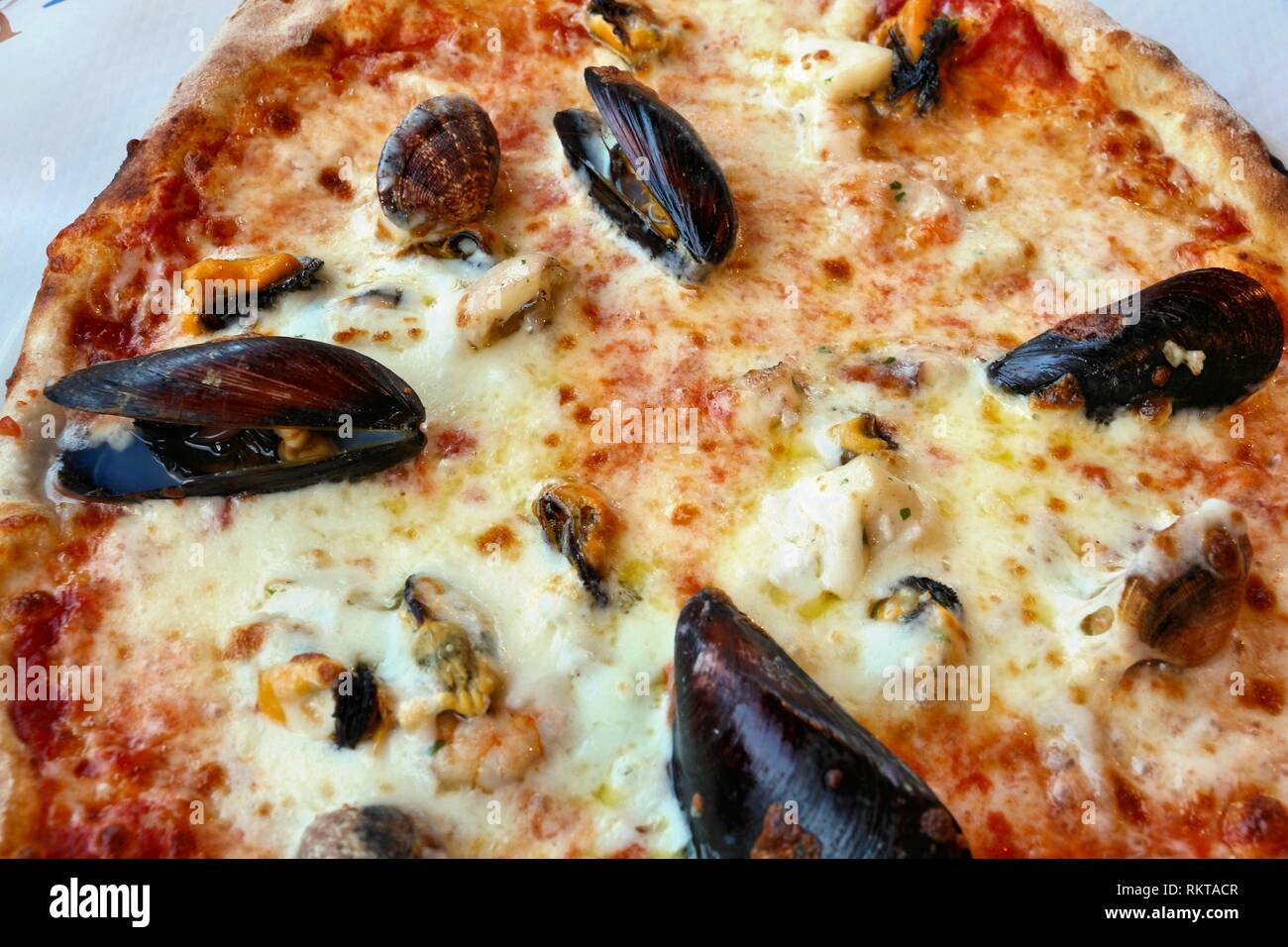 Frutti di mare pizza in Apulia, Italy. Pizza with clams, mussels and shrimps. Stock Photo