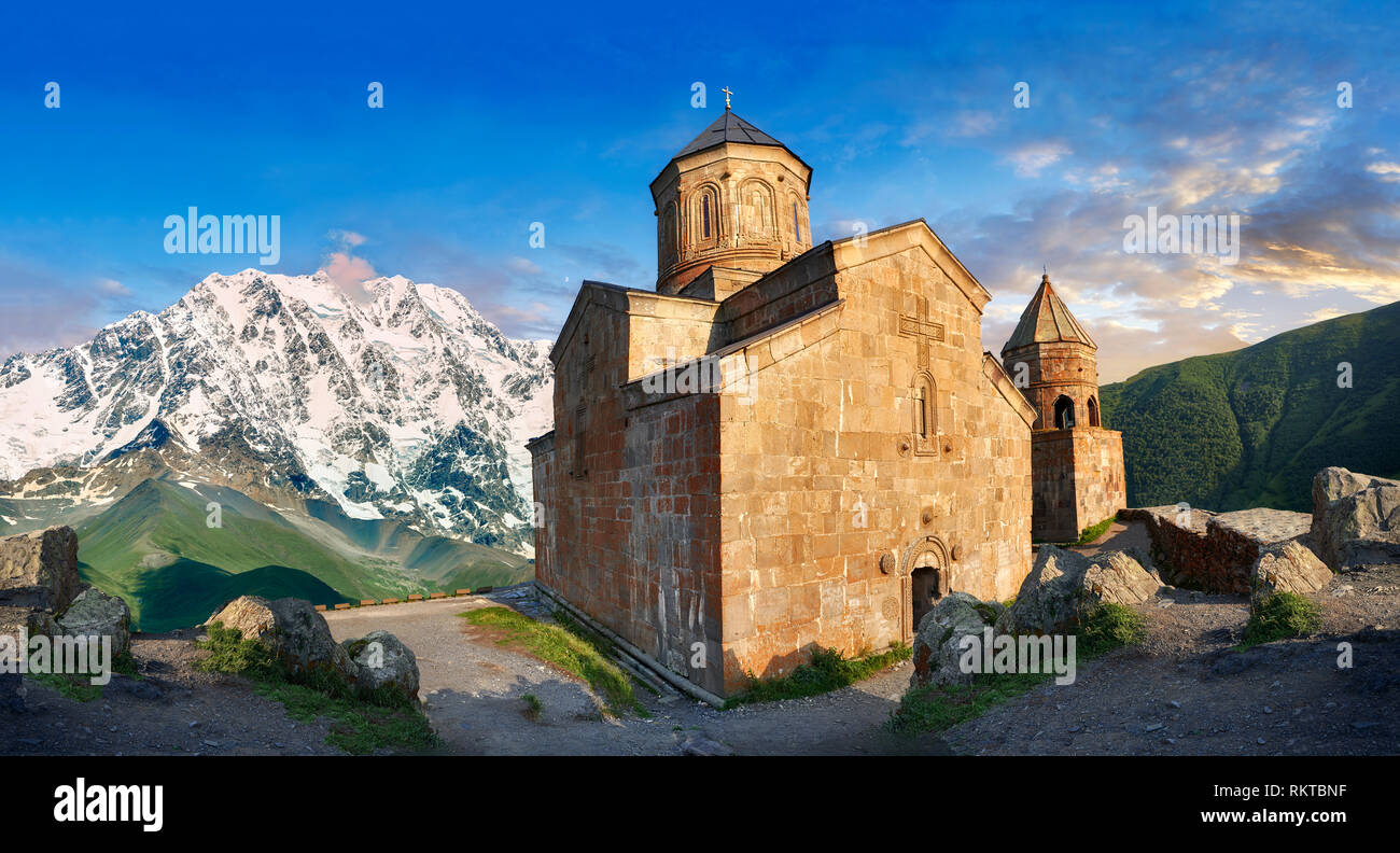 Pictures & images of Gergeti Holy Trinity (Tsminda Sameba) Georgian Orthodox and Apostolic Church and bell tower, 14th century, Gergeti, Khevi provinc Stock Photo