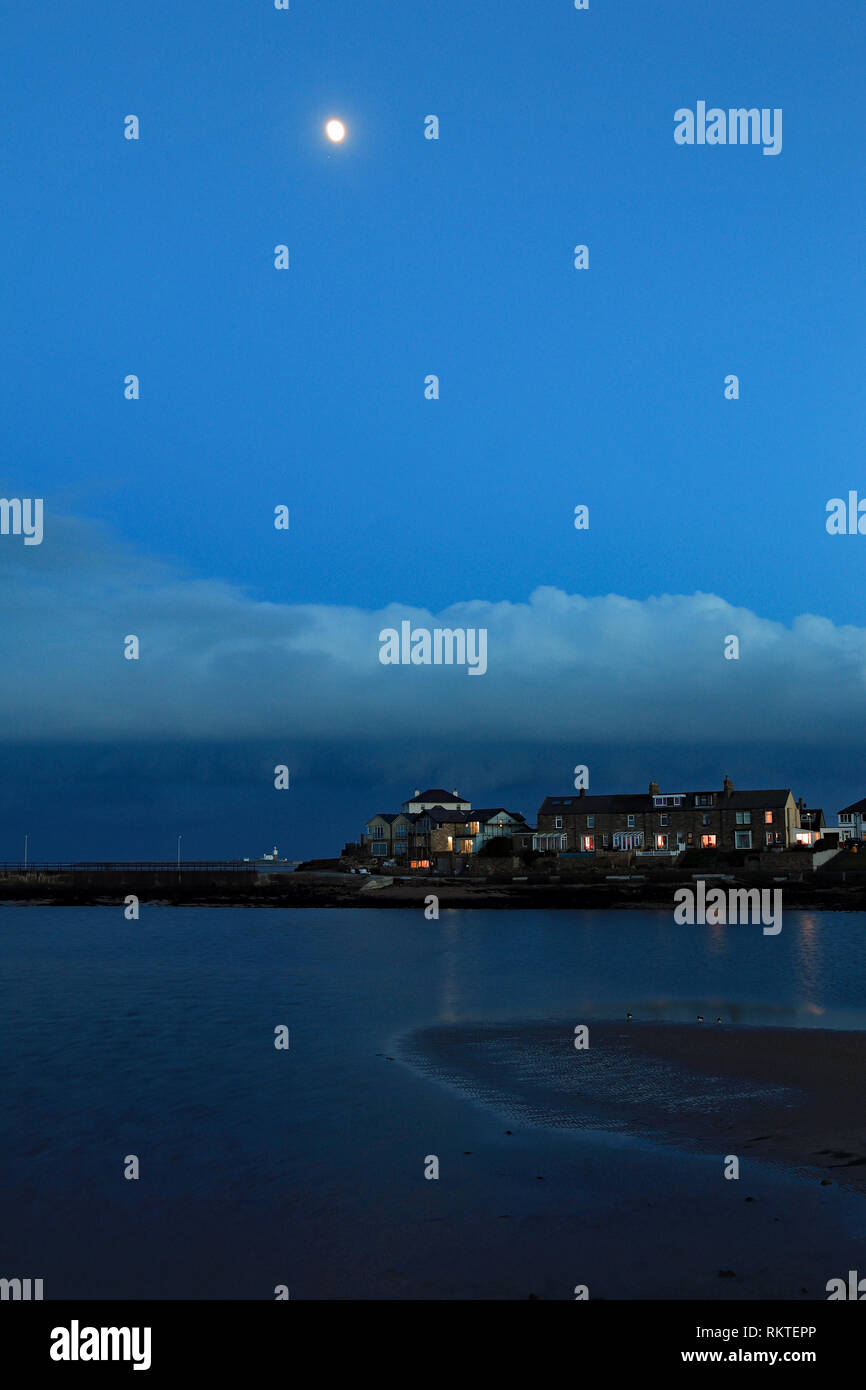 Cw 6596 Amble harbour side under the moon.  Amble is a small town on the north east coast of Northumberland This is the south harbour as dusk falls. Stock Photo