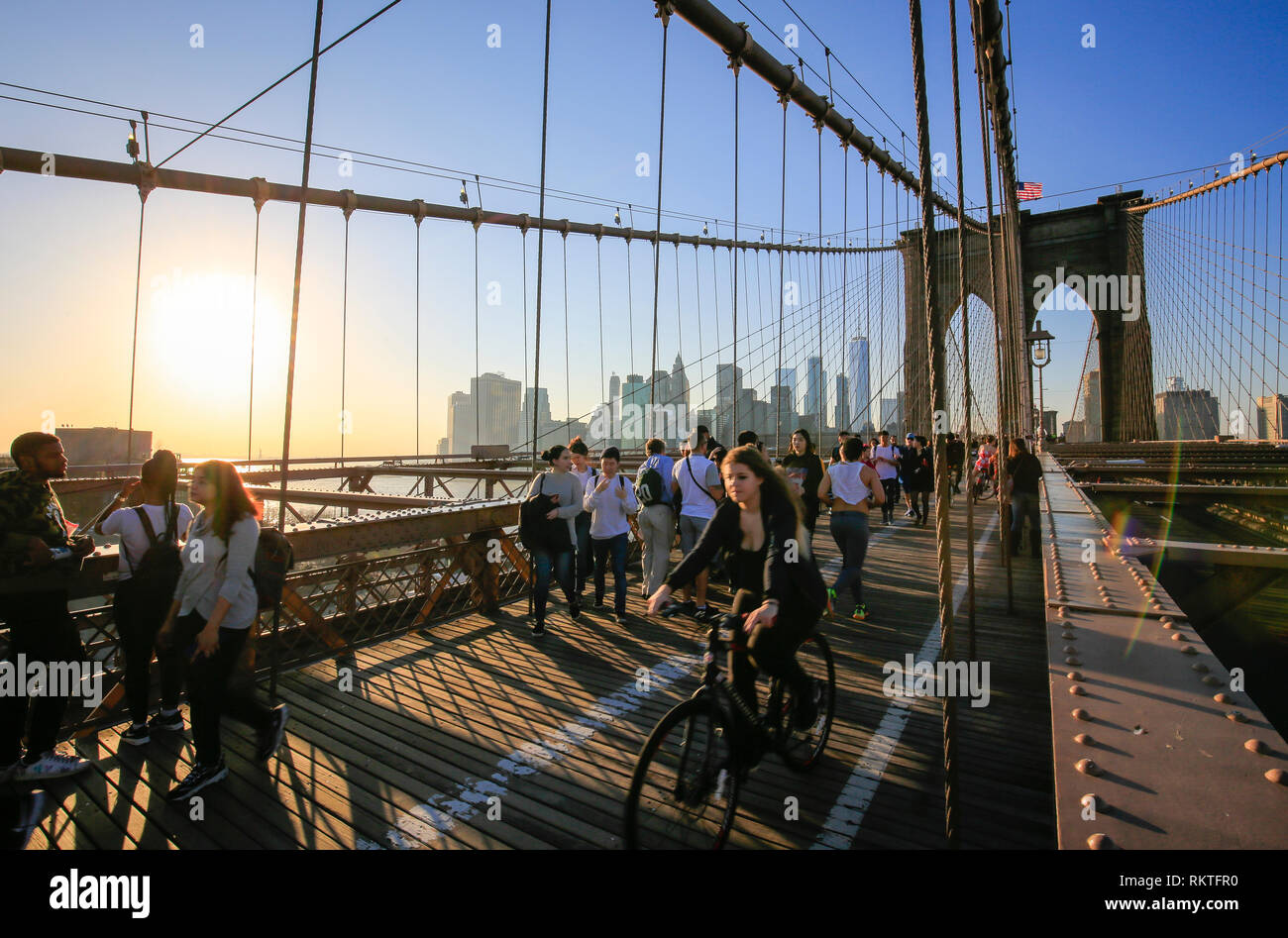 New York City, New York, United States of America - People on the Brooklyn Bridge, view of the Manhattan skyline with Freedom Tower, USA.  New York Ci Stock Photo