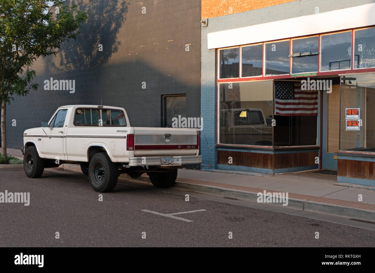 Old Ford pickup truck near closed shop in Winslow, Arizona, United