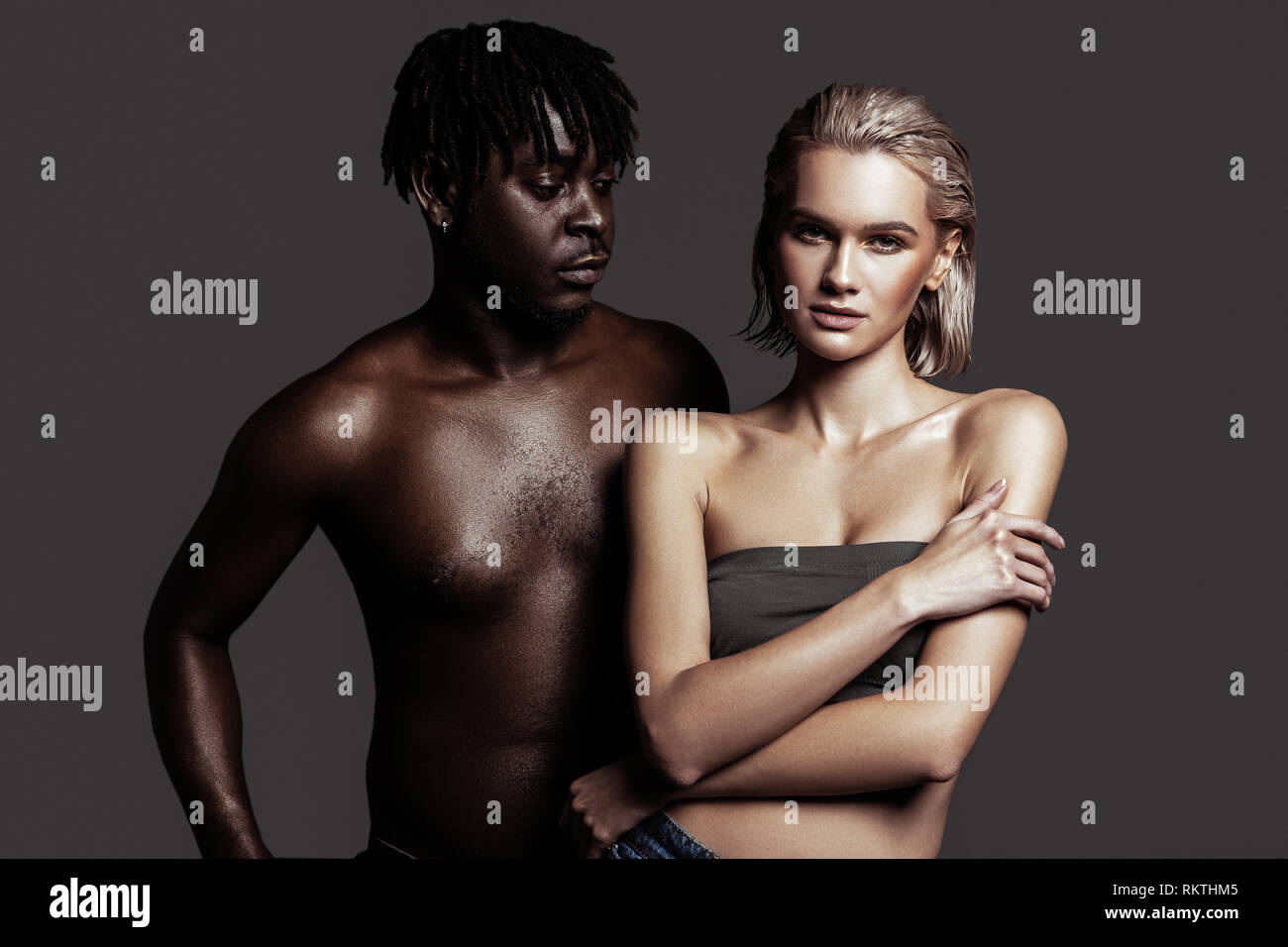 Model with dreadlocks looking at his lovely beautiful colleague Stock Photo