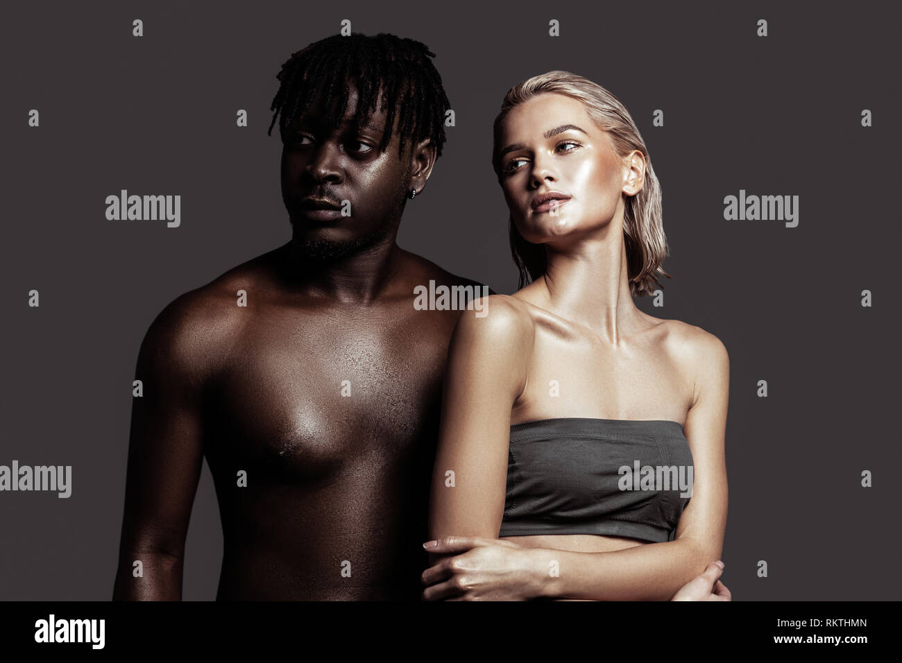 Slim model posing standing near African-American man Stock Photo - Alamy