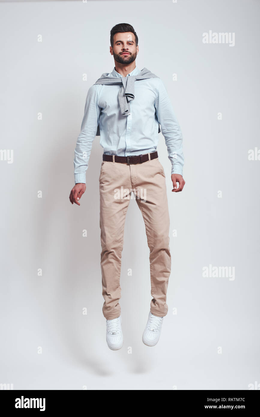 Rocket man. Full length of happy bearded man jumping in studio on a