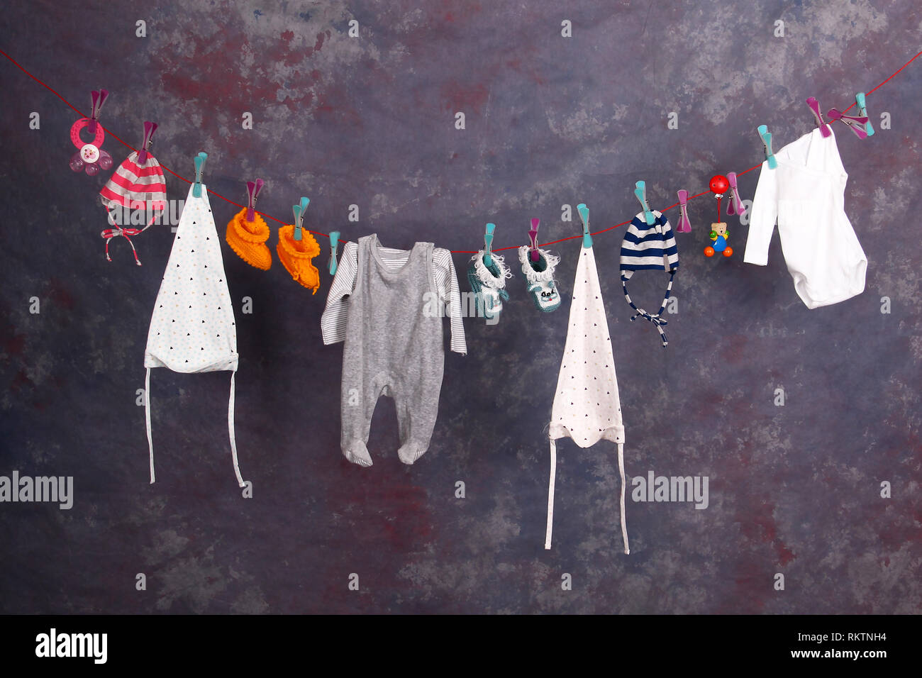 Childhood / Various children's clothing hanging on clothesline Stock