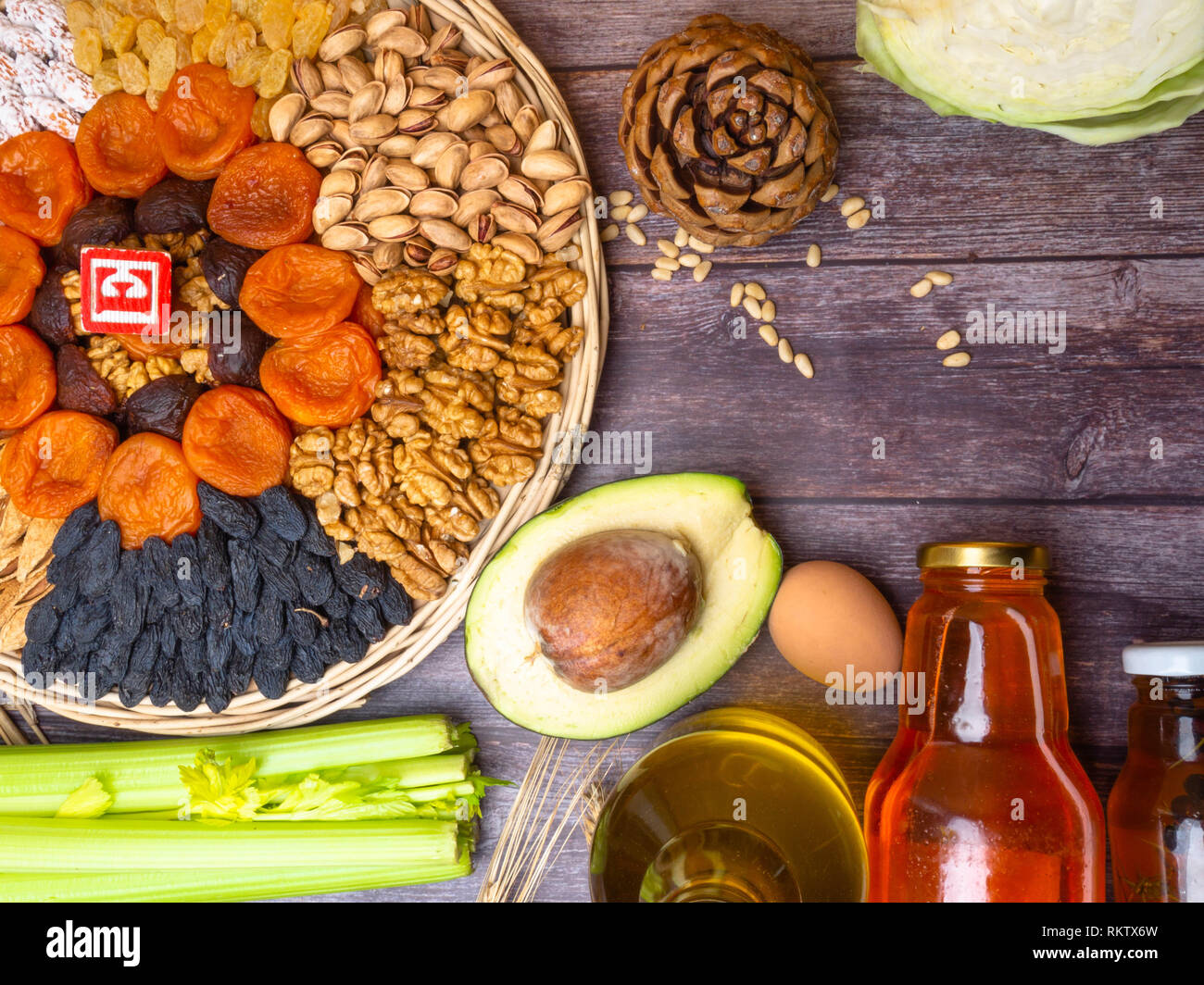 Foods containing vitamin E on wooden surface, copy space Stock Photo