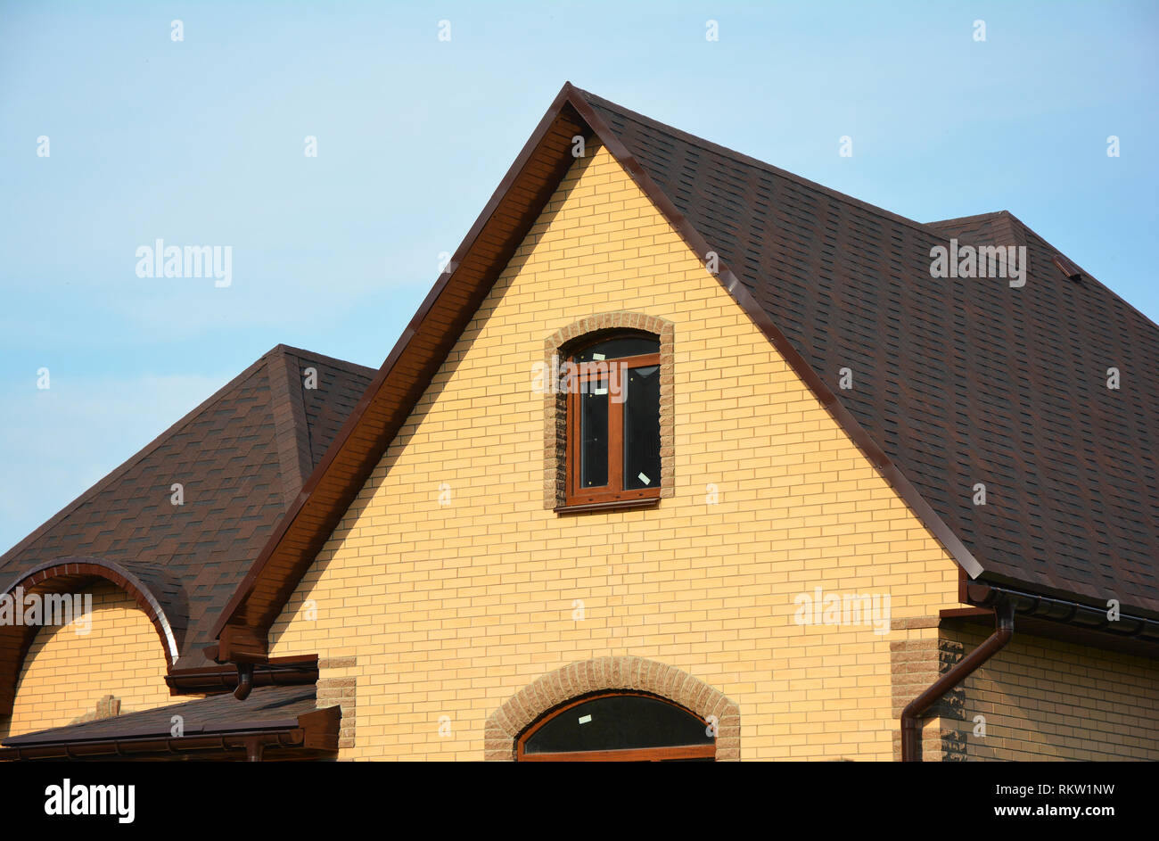 Asphalt Shingles Roofing Advantages. Roofing Construction House Building with Asphalt Shingles