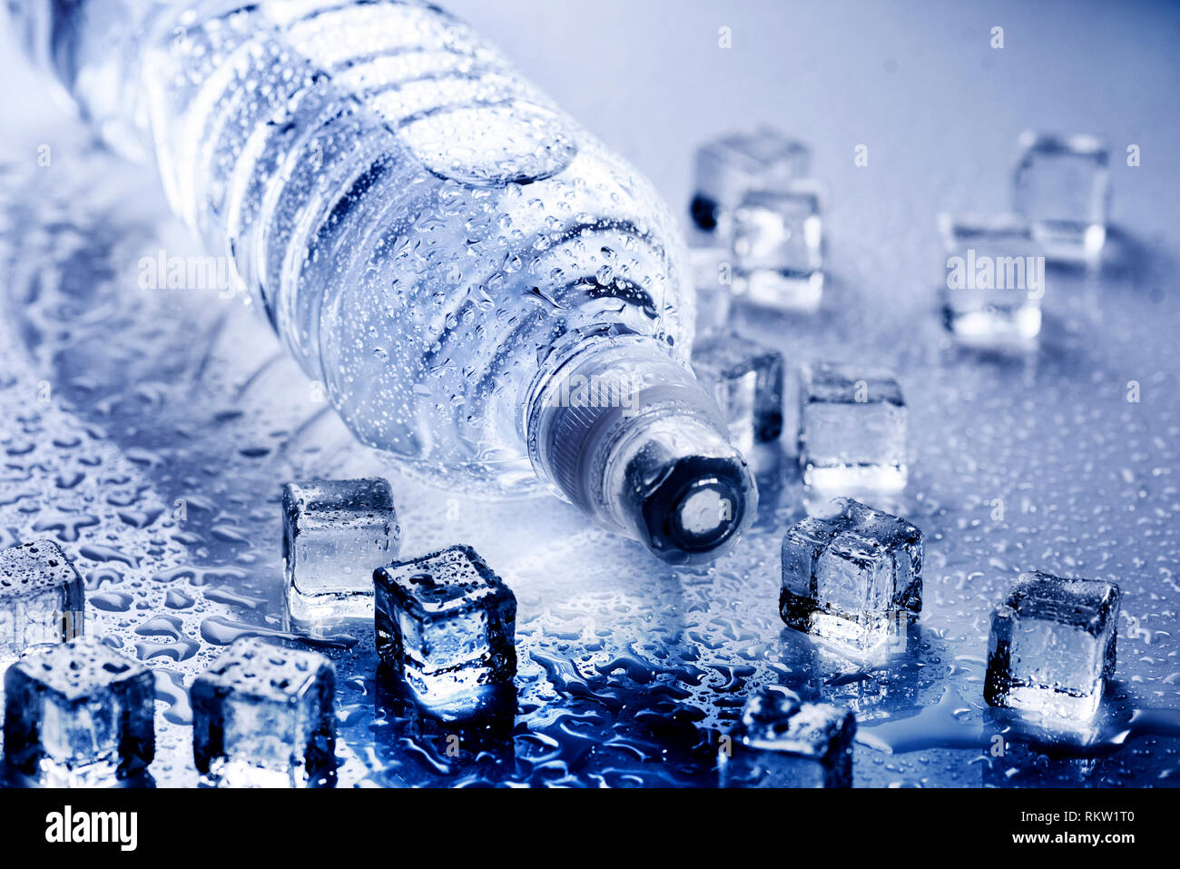 Fresh drinking mineral water in plastic bottle with ice cubes and iced ...