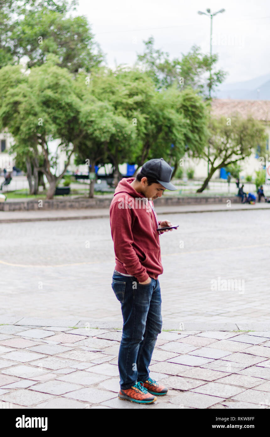 portrait of my friend Cholo Ivan, modern young man with mobile phone in the streets of Cusco - Peru Stock Photo - Alamy