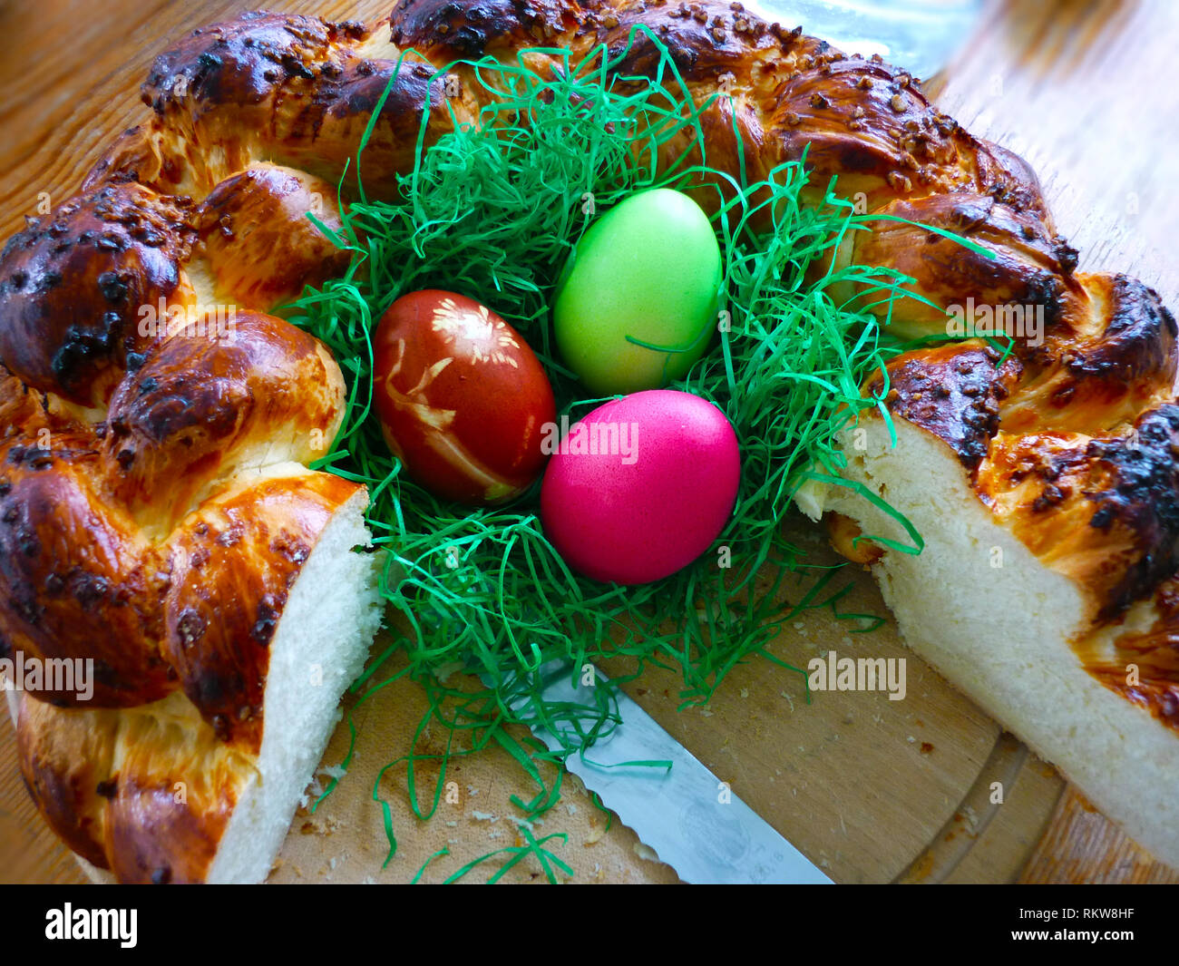 Colorful easter eggs in bowl with decorative chicken Stock Photo