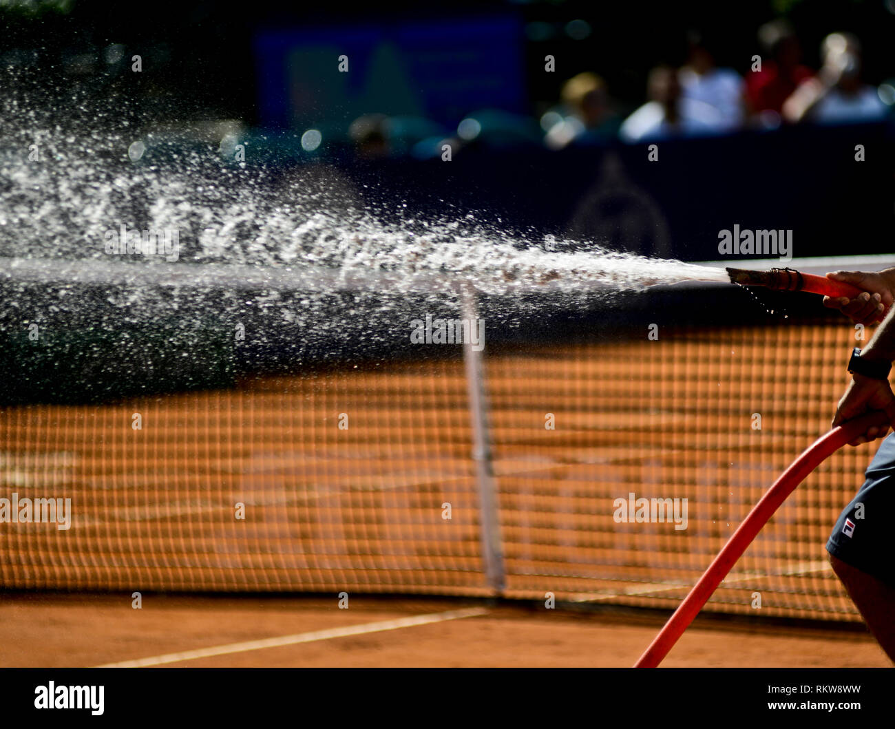 Watering the surface of a tennis clay court. Argentina Open 2019 Stock