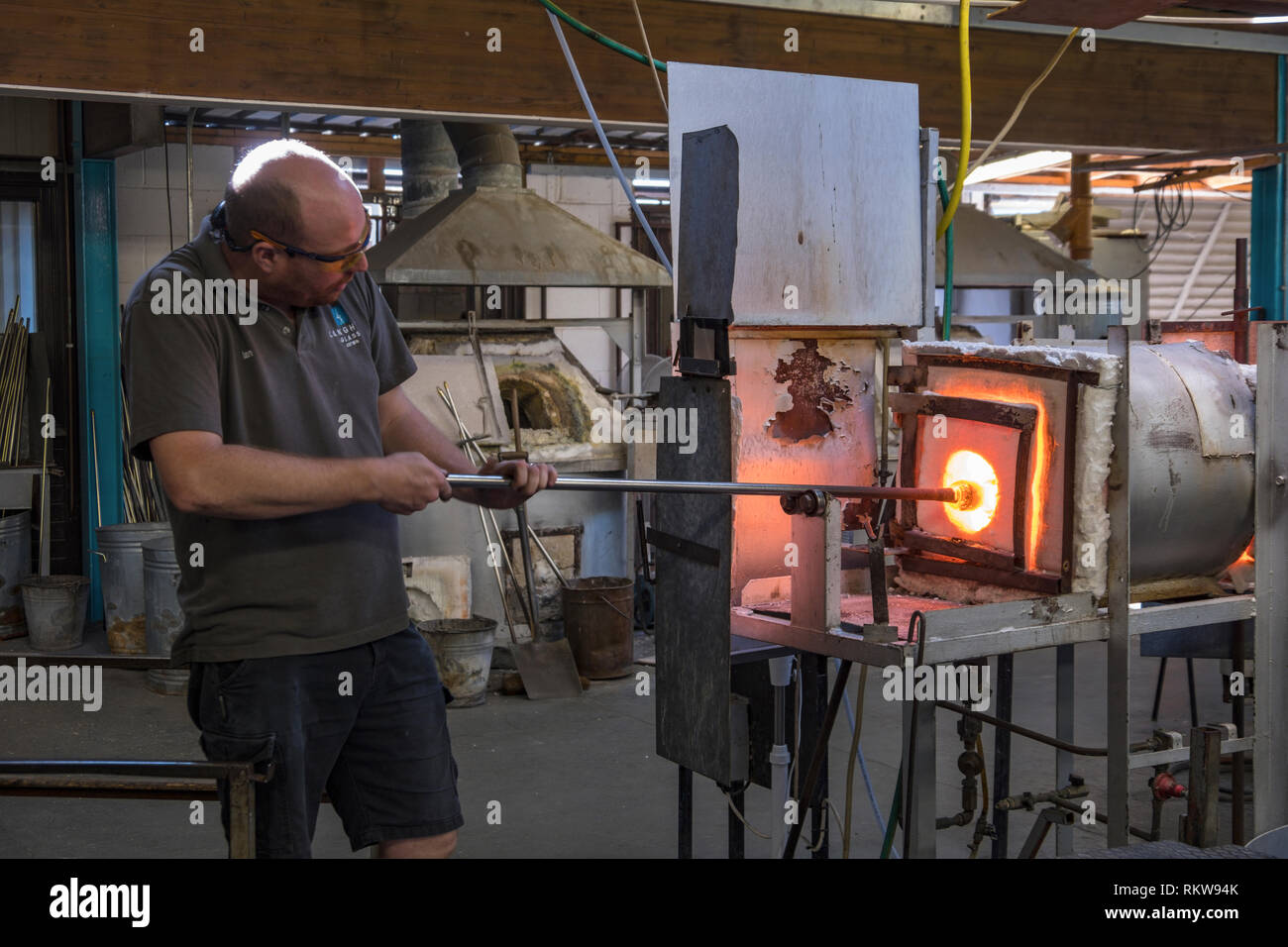 A glassblower heating glass in a furnace Stock Photo Alamy