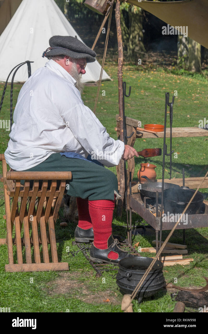 A member of the Sealed Knot cooking at a re-enactment. Stock Photo