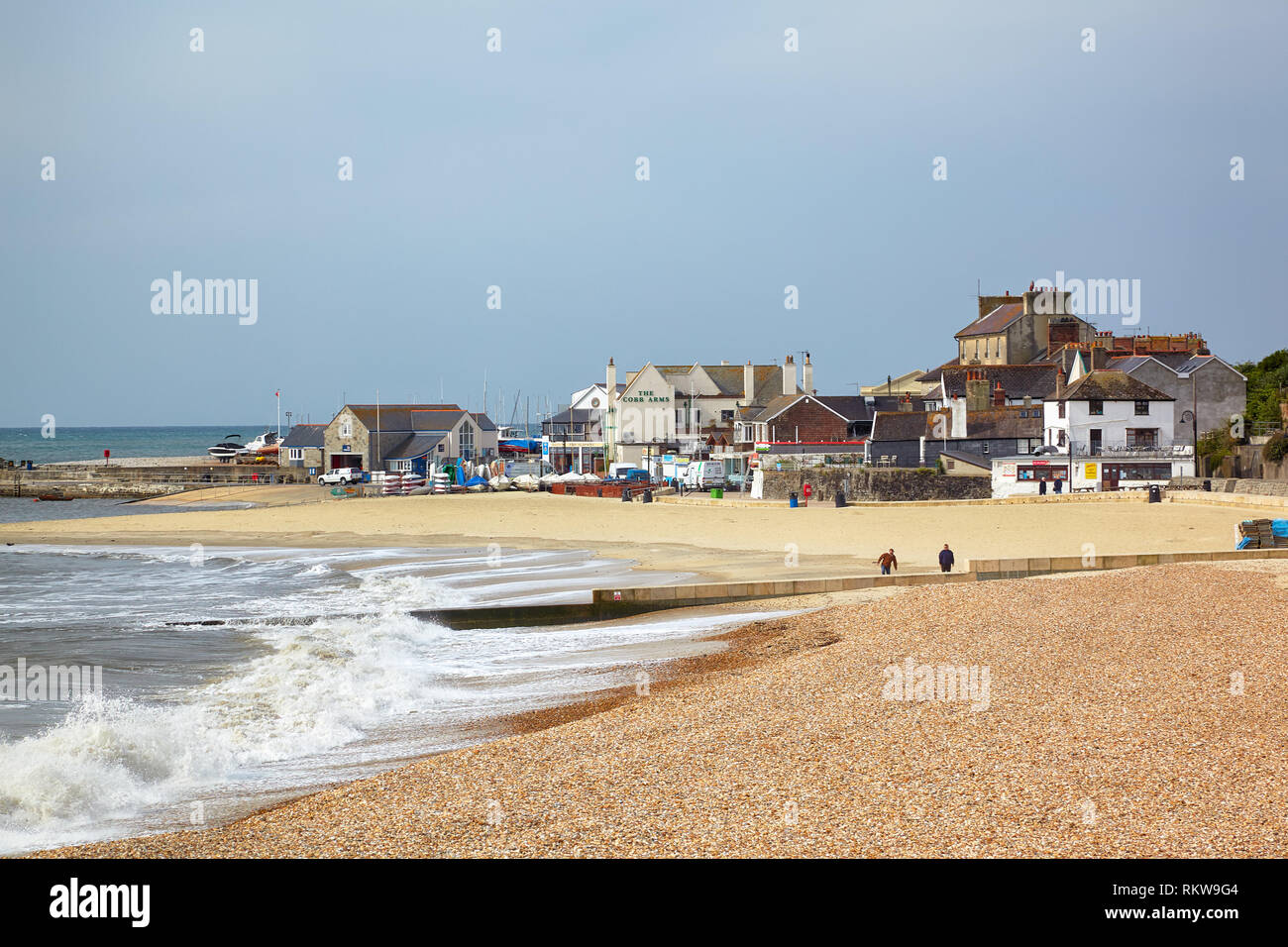 The view of the sandy coast at Cobb harbor in Lyme Bay. Lyme Regis. West Dorset. England Stock Photo