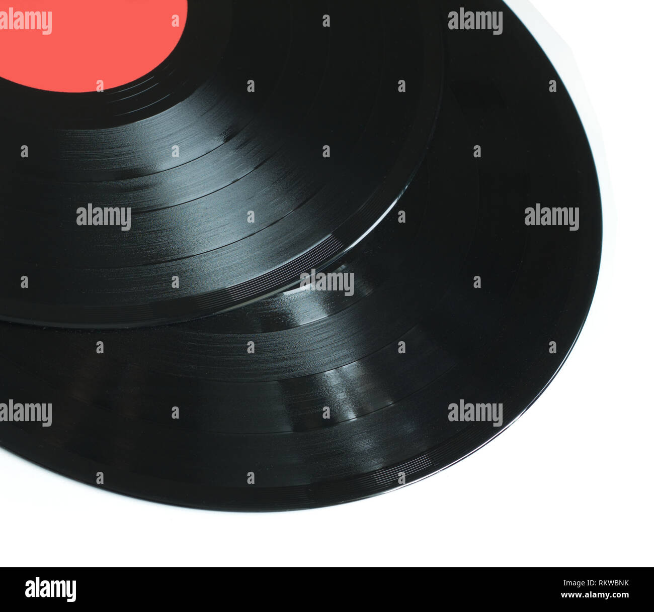 Part of two black longplay vinyl records with red label isolated on