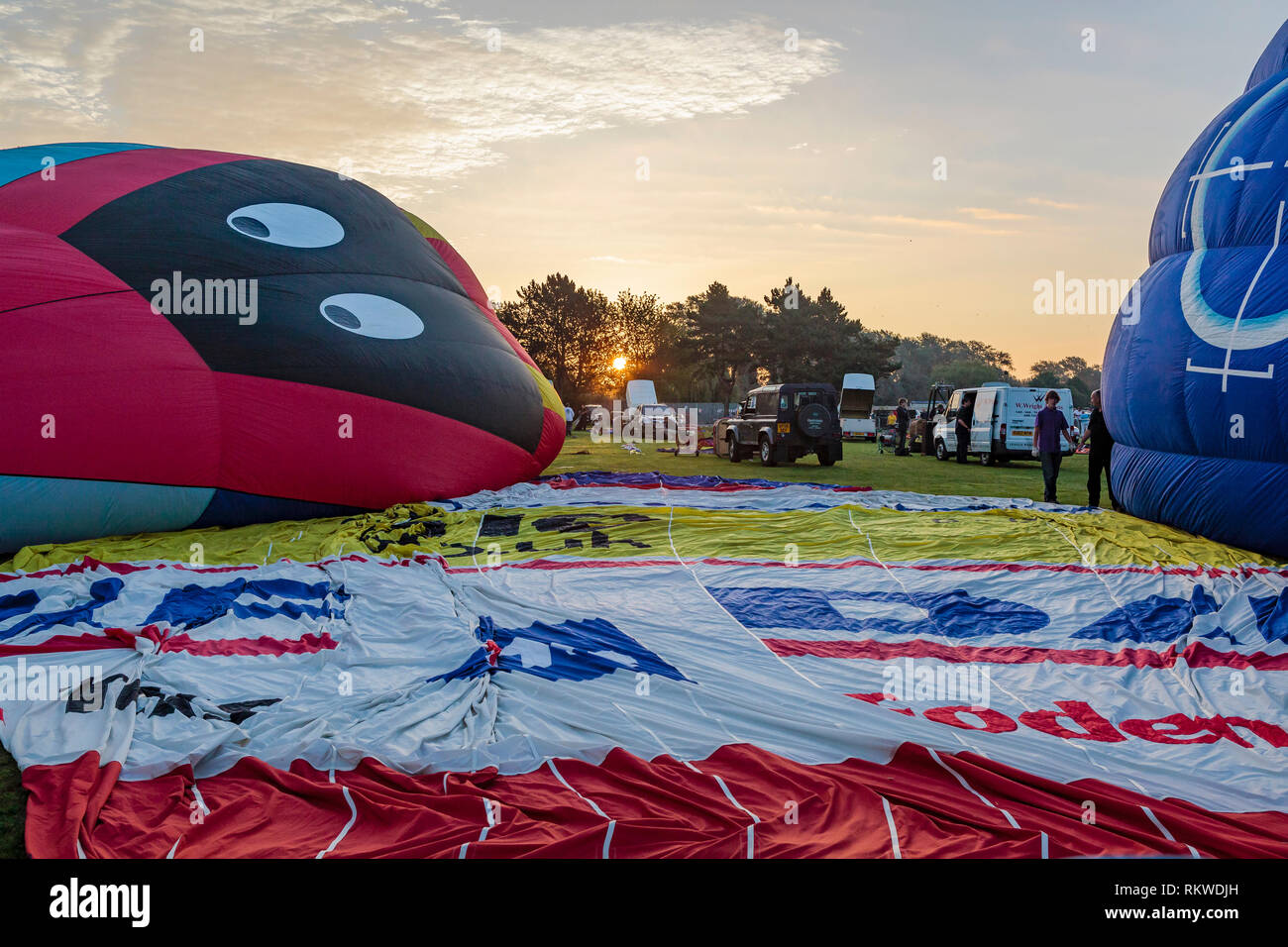 Ballons inflating at sunrise during the Northampton Balloon festival. Stock Photo