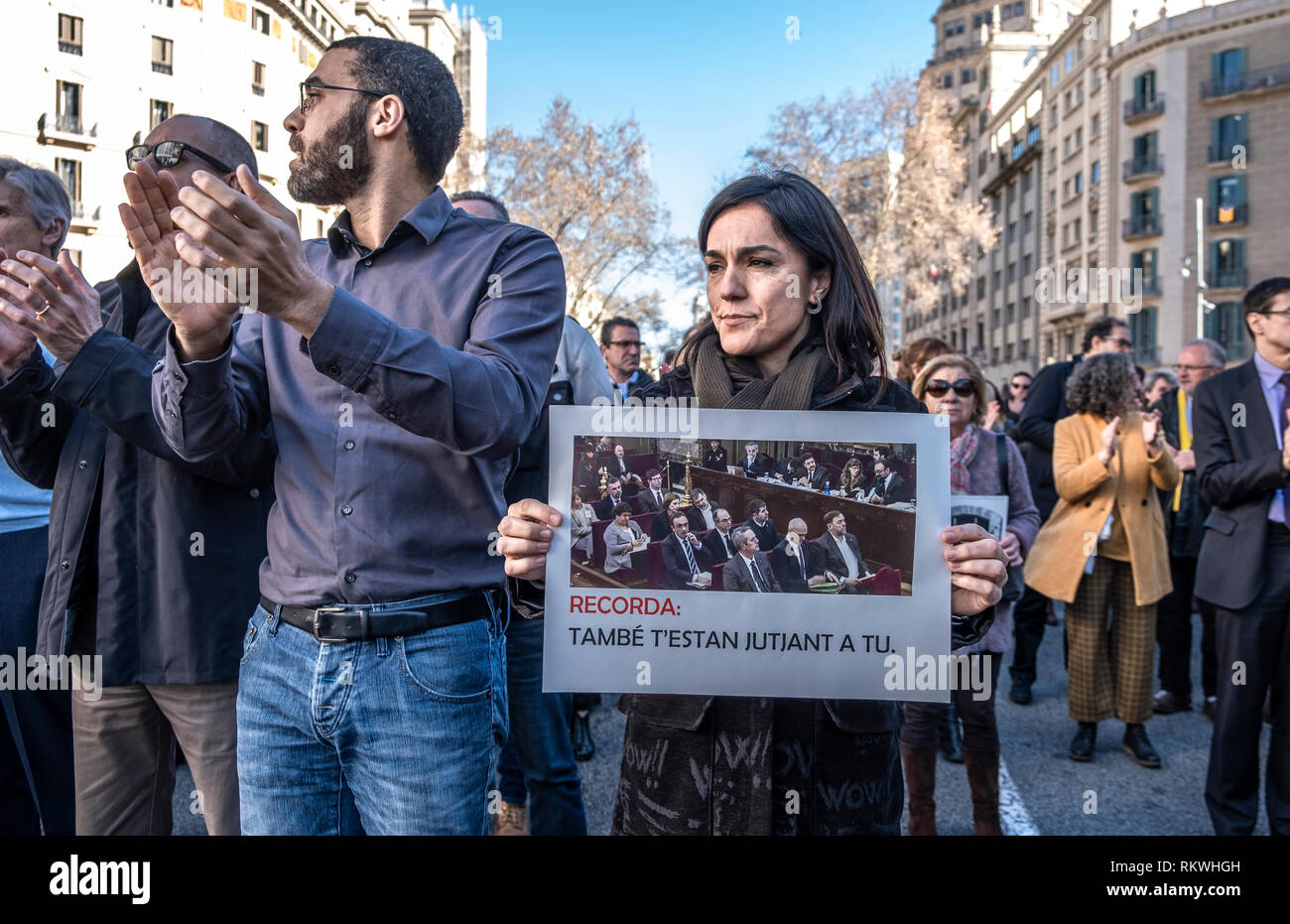 Barcelona, Spain. 12th Feb 2019. A worker from the Department of Economy and Finance is seen during the protest showing an image taken from TV showing the first portrait image of the political prisoners since they were arrested. Hundreds of workers and officials of the General office of Catalonia have gone out to show their solidarity with political prisoners on their first day of trial.  The workers of the Department of Economy have blocked the traffic of the Gran Vía during the protest. Credit: SOPA Images Limited/Alamy Live News Stock Photo
