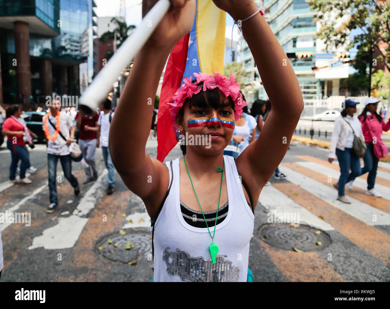 Caracas, Venezuela. 12th Feb, 2019. A young woman goes to a rally of government opponents in the Venezuelan capital. On the occasion of Youth Day, demonstrators called on the armed forces to let humanitarian aid into the country for the suffering population. Since last week, ten trucks with about 100 tons of relief supplies have been waiting in the Colombian border town of Cúcuta for permission to pass. Credit: Rafael Hernandez/dpa/Alamy Live News Stock Photo