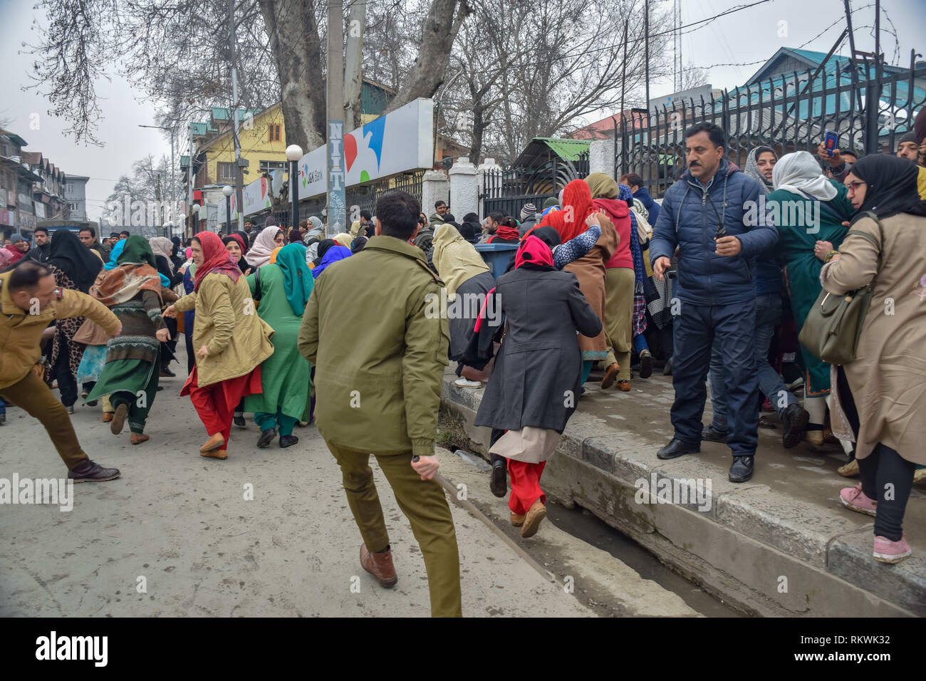 February 12, 2019 - Srinagar, Jammu & Kashmir - Members of Jammu and Kashmir police are seen charging batons over the NHM employees during protest in Srinagar.NHM (National Health Mission) employees on took out an anti-government protest march towards the Raj Bhavan in Srinagar. The employees who have been on a strike since the past thirty days are demanding regularization in a phased manner, equal pay for equal work and other social security benefits. Police used batons on the Protesters and many of them were detained during the protest. (Credit Image: © Idrees Abbas/SOPA Images via Z Stock Photo