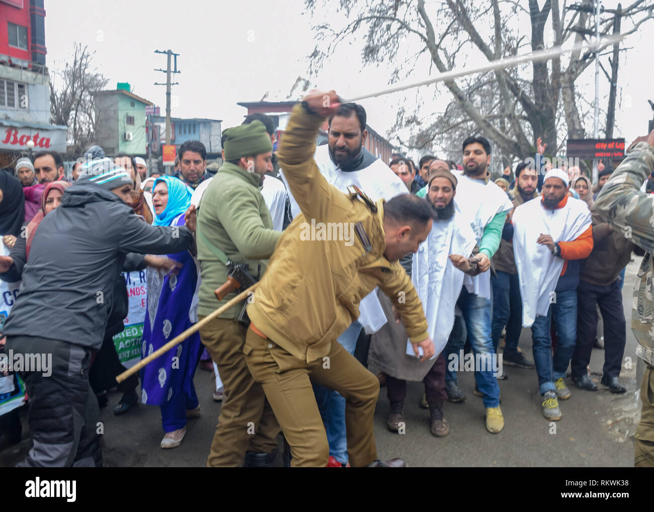 February 12, 2019 - Srinagar, Jammu & Kashmir - Members of Jammu and Kashmir police are seen charging batons over the NHM employees during protest in Srinagar.NHM (National Health Mission) employees on took out an anti-government protest march towards the Raj Bhavan in Srinagar. The employees who have been on a strike since the past thirty days are demanding regularization in a phased manner, equal pay for equal work and other social security benefits. Police used batons on the Protesters and many of them were detained during the protest. (Credit Image: © Idrees Abbas/SOPA Images via Z Stock Photo