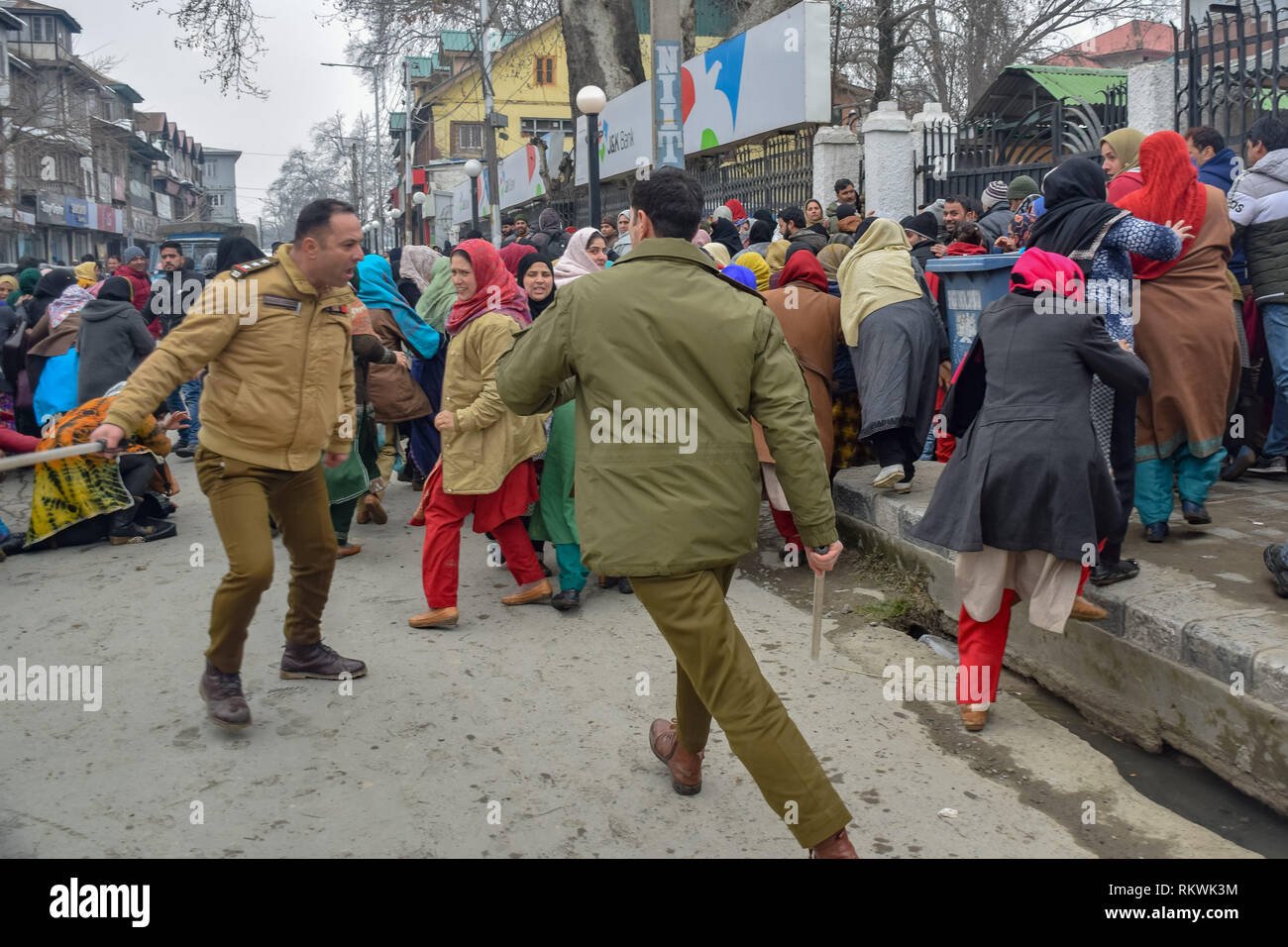 February 12, 2019 - Srinagar, Jammu & Kashmir - Members of Jammu and Kashmir police are seen charging batons over the NHM employees during protest in Srinagar.NHM (National Health Mission) employees on took out an anti-government protest march towards the Raj Bhavan in Srinagar. The employees who have been on a strike since the past thirty days are demanding regularization in a phased manner, equal pay for equal work and other social security benefits. Police used batons on the Protesters and many of them were detained during the protest. (Credit Image: © Idrees Abbas/SOPA Images via Z Stock Photo
