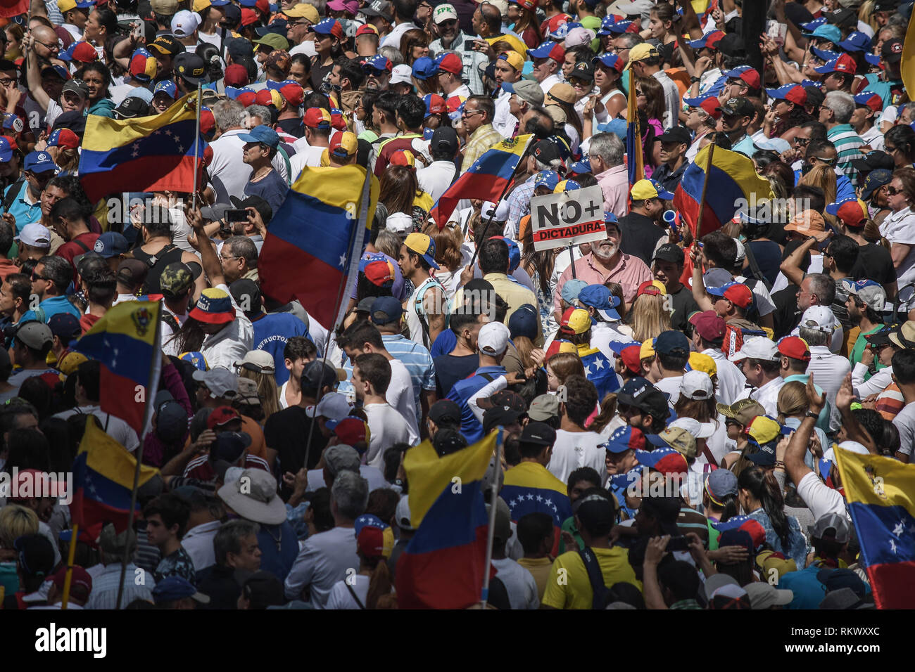 A view of the crowd during a protest to call for a change in the government. Opponents gather at a protest organised by the PSUV (United Socialist Party of Venezuela) after the call from interim president Juan Guaido, to show their support to him, while asking the army to allow more humanitarian aids into the country. Stock Photo