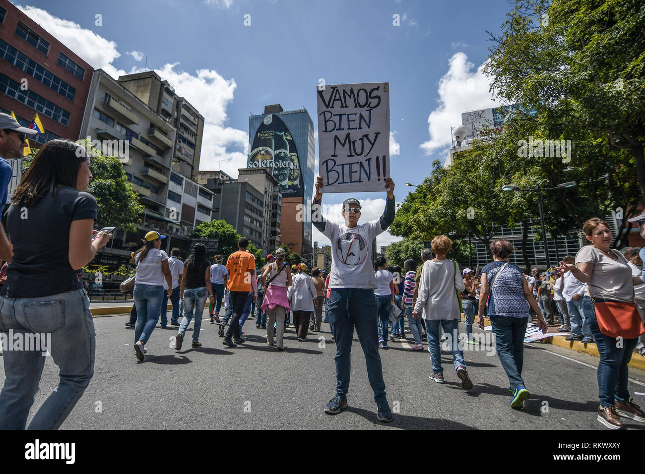 A man seen holding a placard in the air during a protest to call for a change in the government. Opponents gather at a protest organised by the PSUV (United Socialist Party of Venezuela) after the call from interim president Juan Guaido, to show their support to him, while asking the army to allow more humanitarian aids into the country. Stock Photo