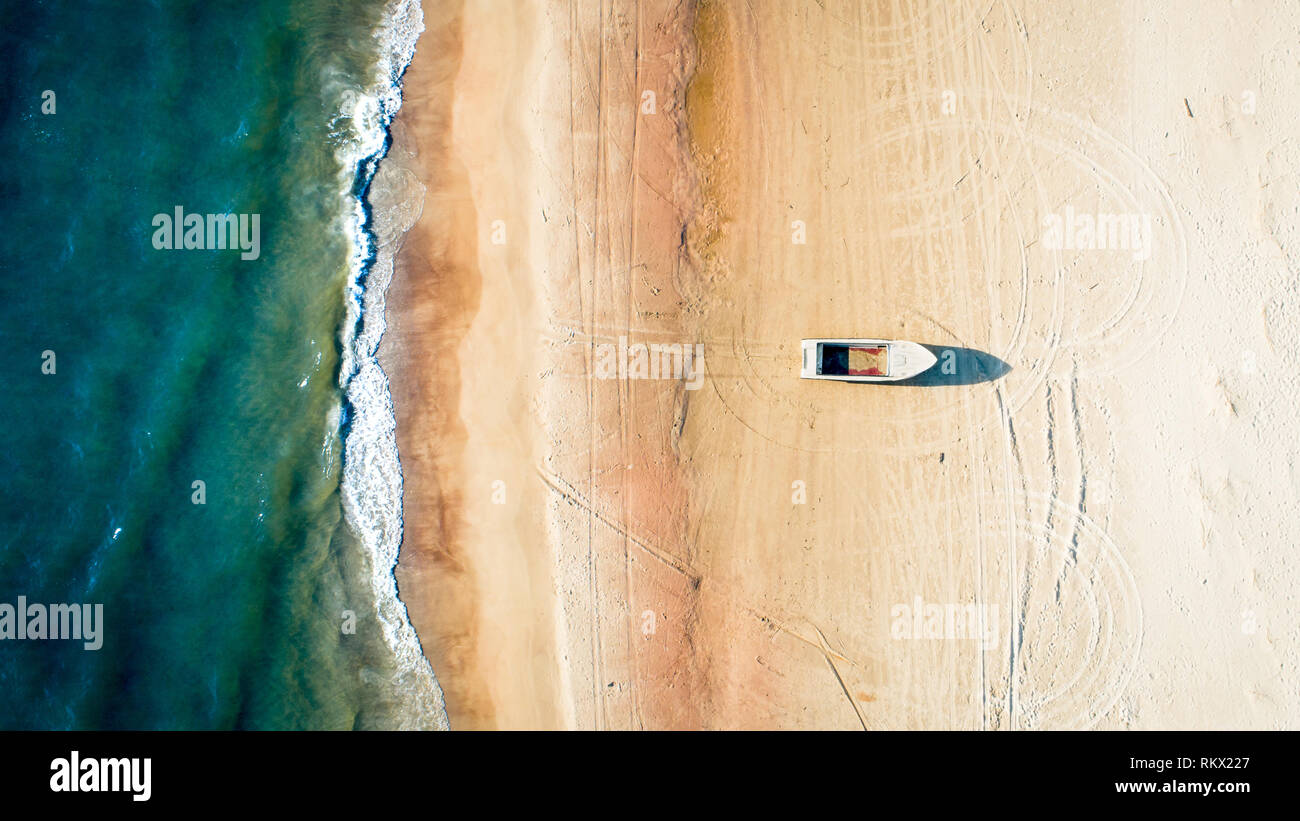 Boat on the Beach, Aerial Vertical Top Down View Stock Photo