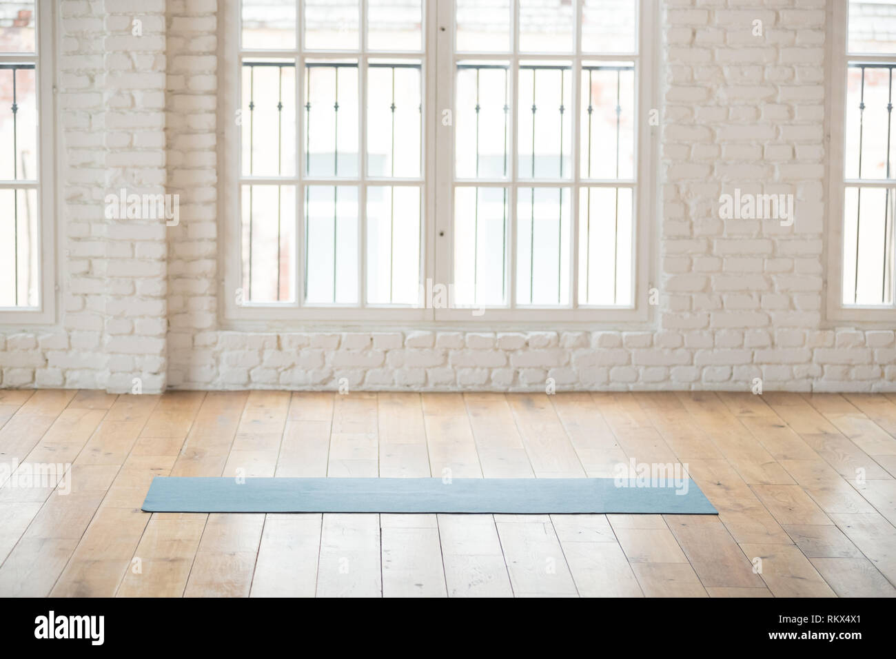 Unrolled Yoga Mat In Empty Fitness Studio Stock Photo 235987865