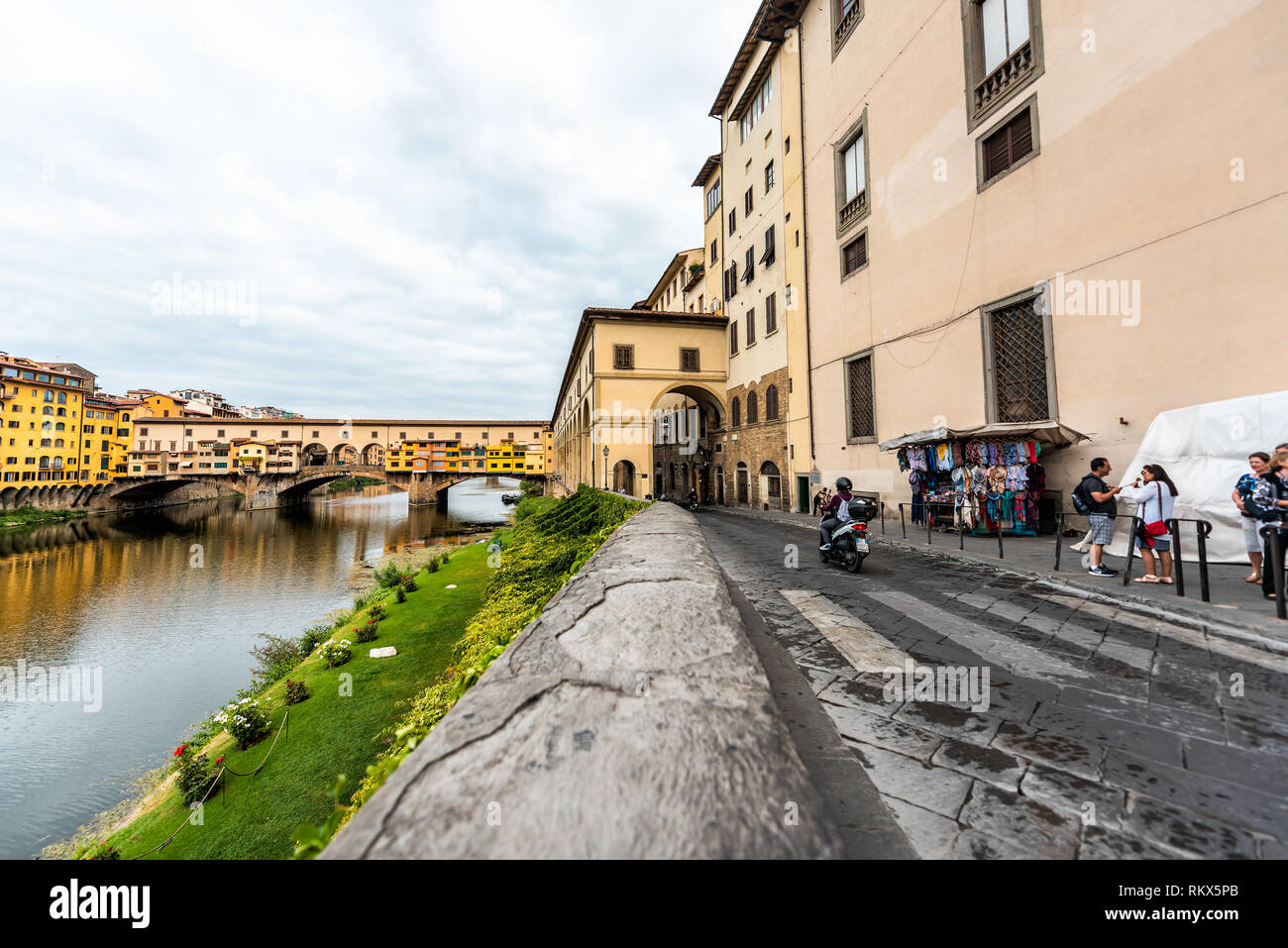Florence, Italy - August 31, 2018: Firenze orange yellow colorful buildings and Arno river during summer morning in Tuscany and vendors Stock Photo