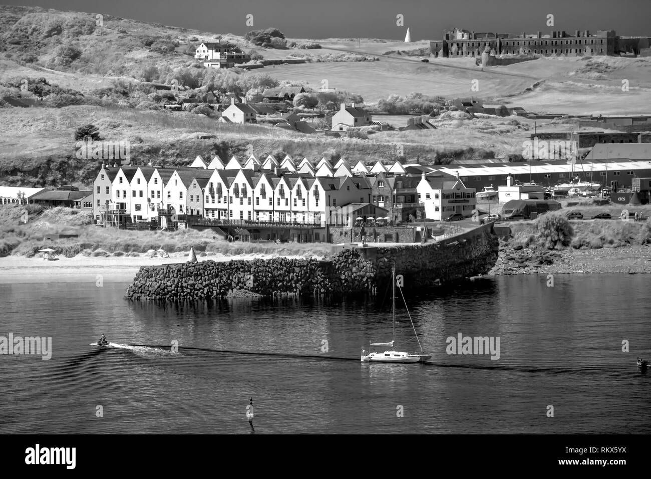 An infrared monochrome image of the English Row in Braye harbour, on Alderney, Channel Islands. Stock Photo